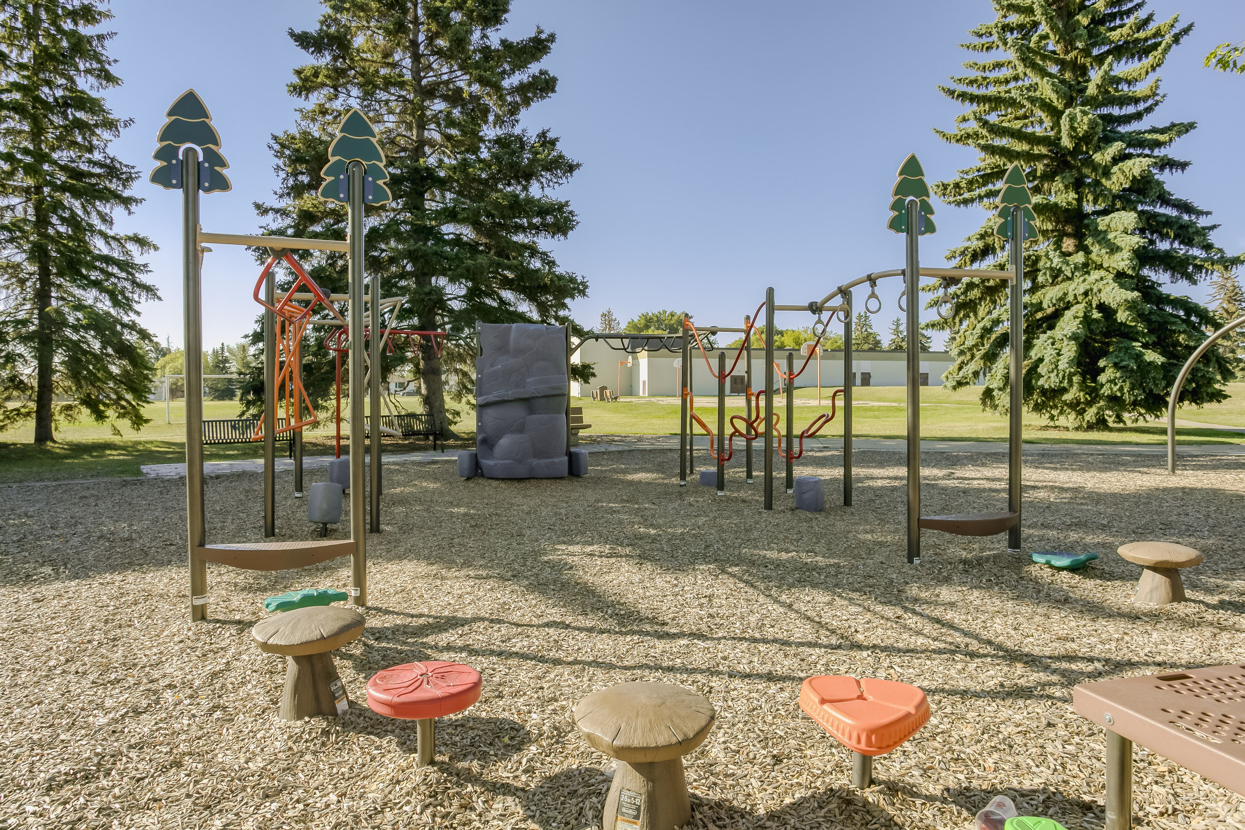 Rundle Heights Community Playground playground equipment in Edmonton, AB with inclusive play features