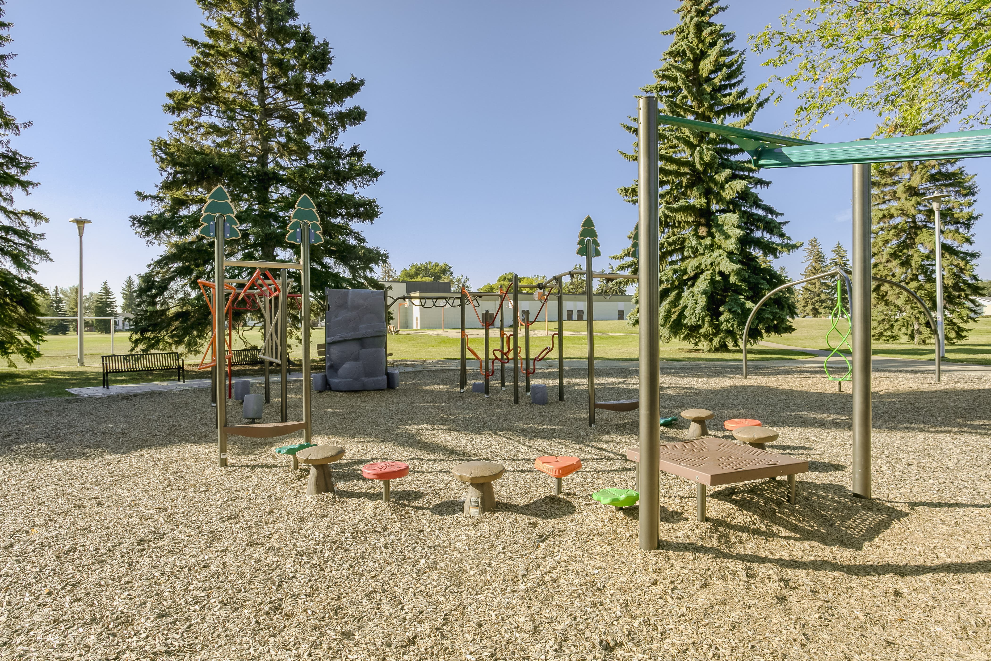 Rundle Heights Community Playground playground equipment in Edmonton, AB featuring curved spiral slide