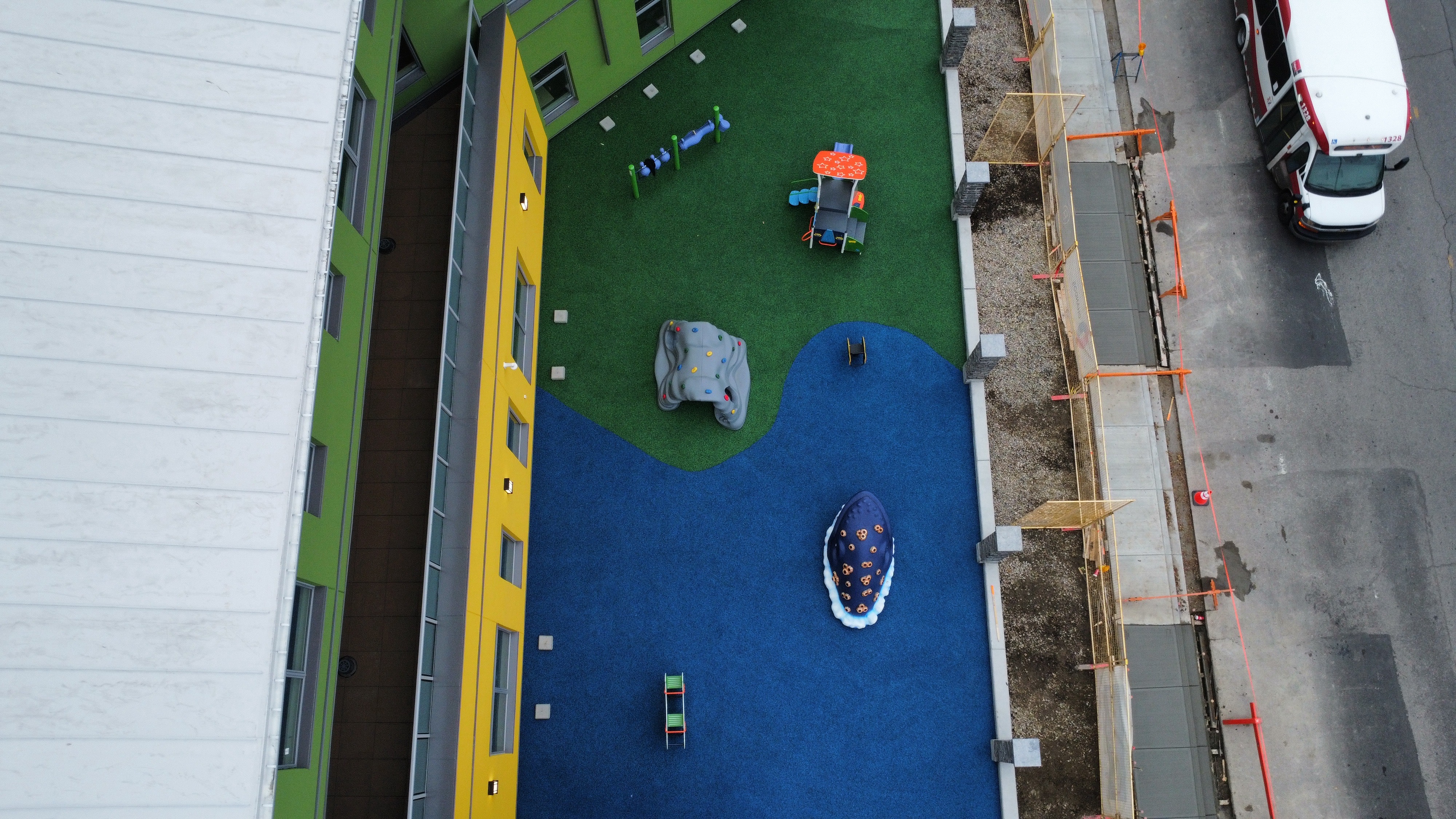 Children's Cottage Society playground equipment in Calgary, AB with climbing and sliding features