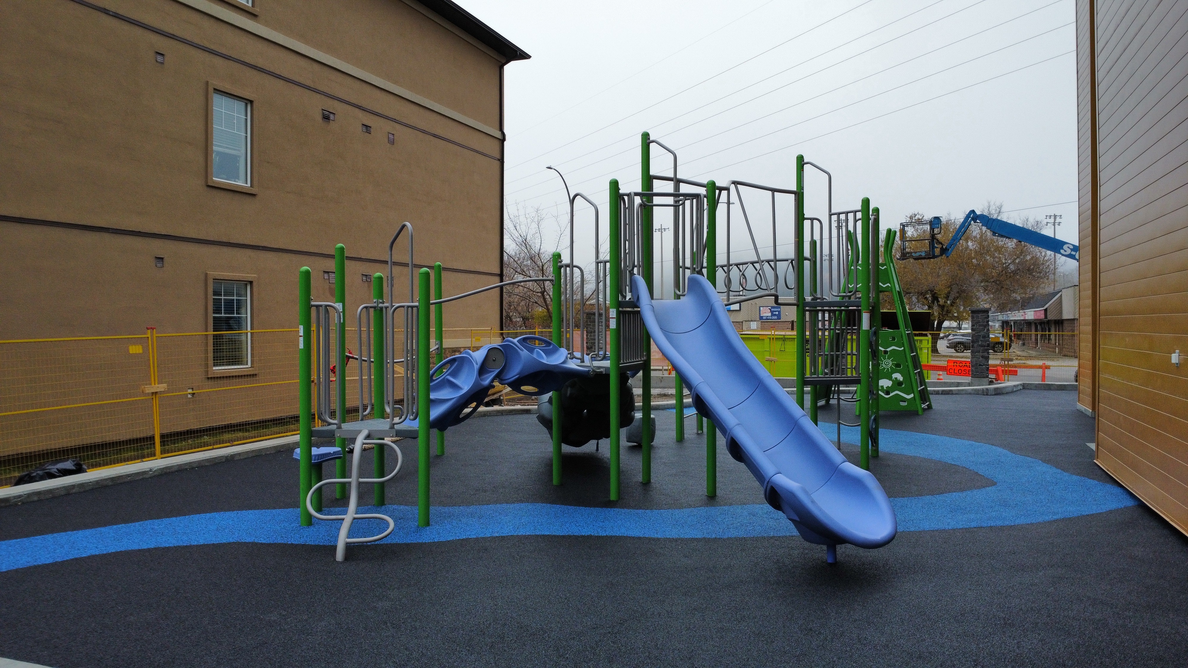 Children's Cottage Society playground equipment in Calgary, AB featuring colorful play structures
