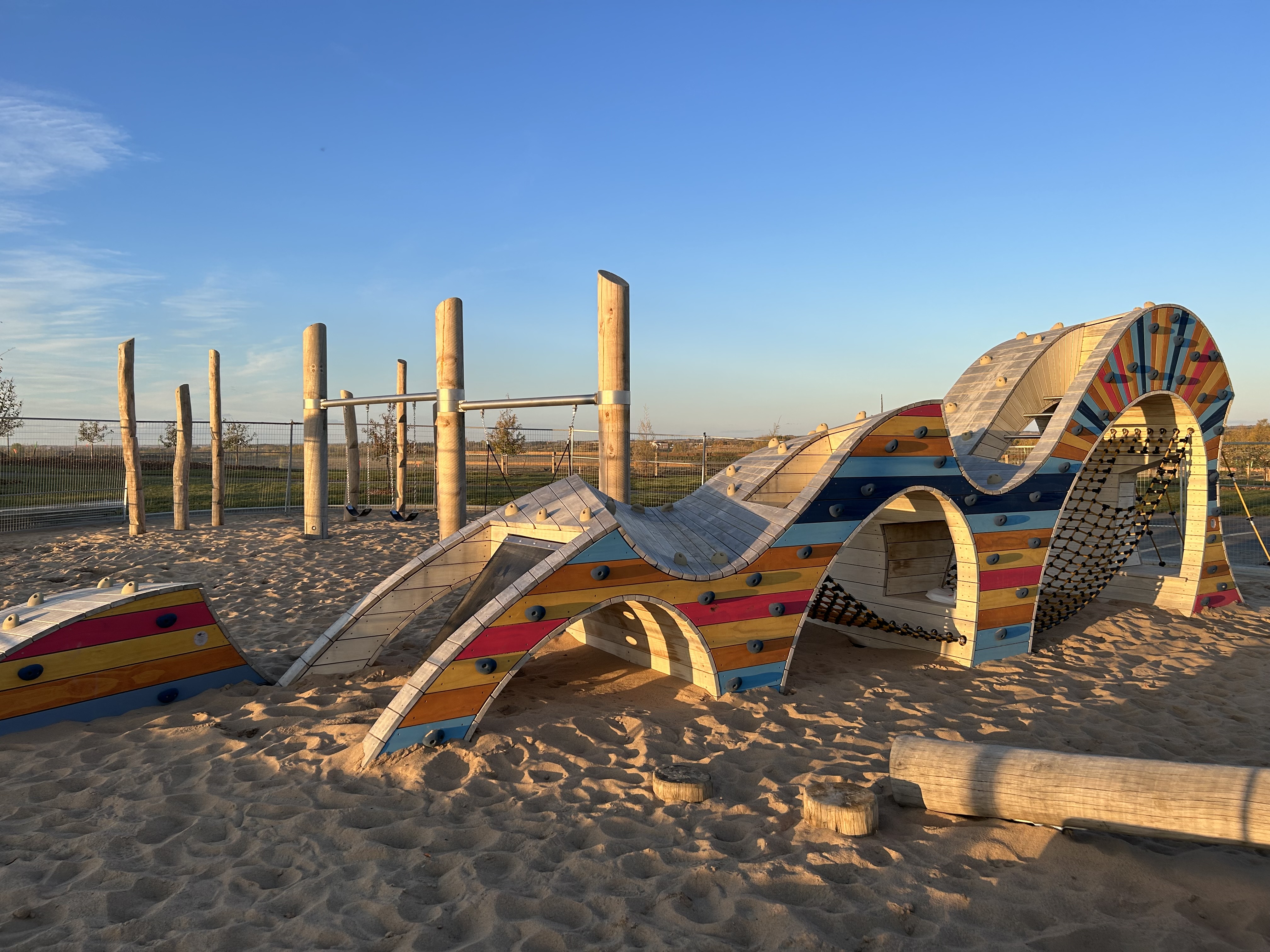 Cambrian Playground in Sherwood Park, AB featuring playground equipment with Wave climber structure, natural playground