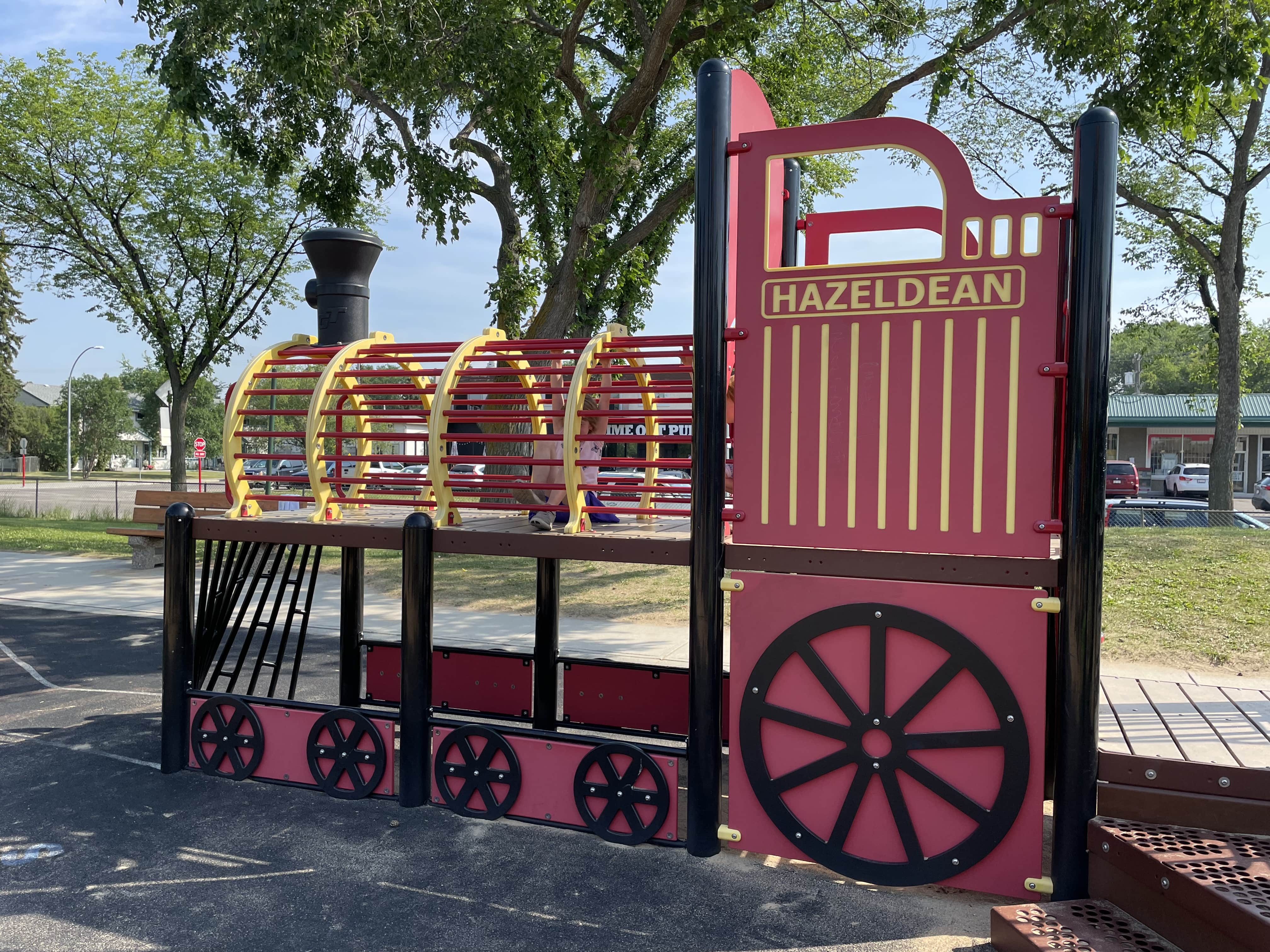 Hazeldean Park in Edmonton, AB featuring playground equipment with train-themed playground, two great trains