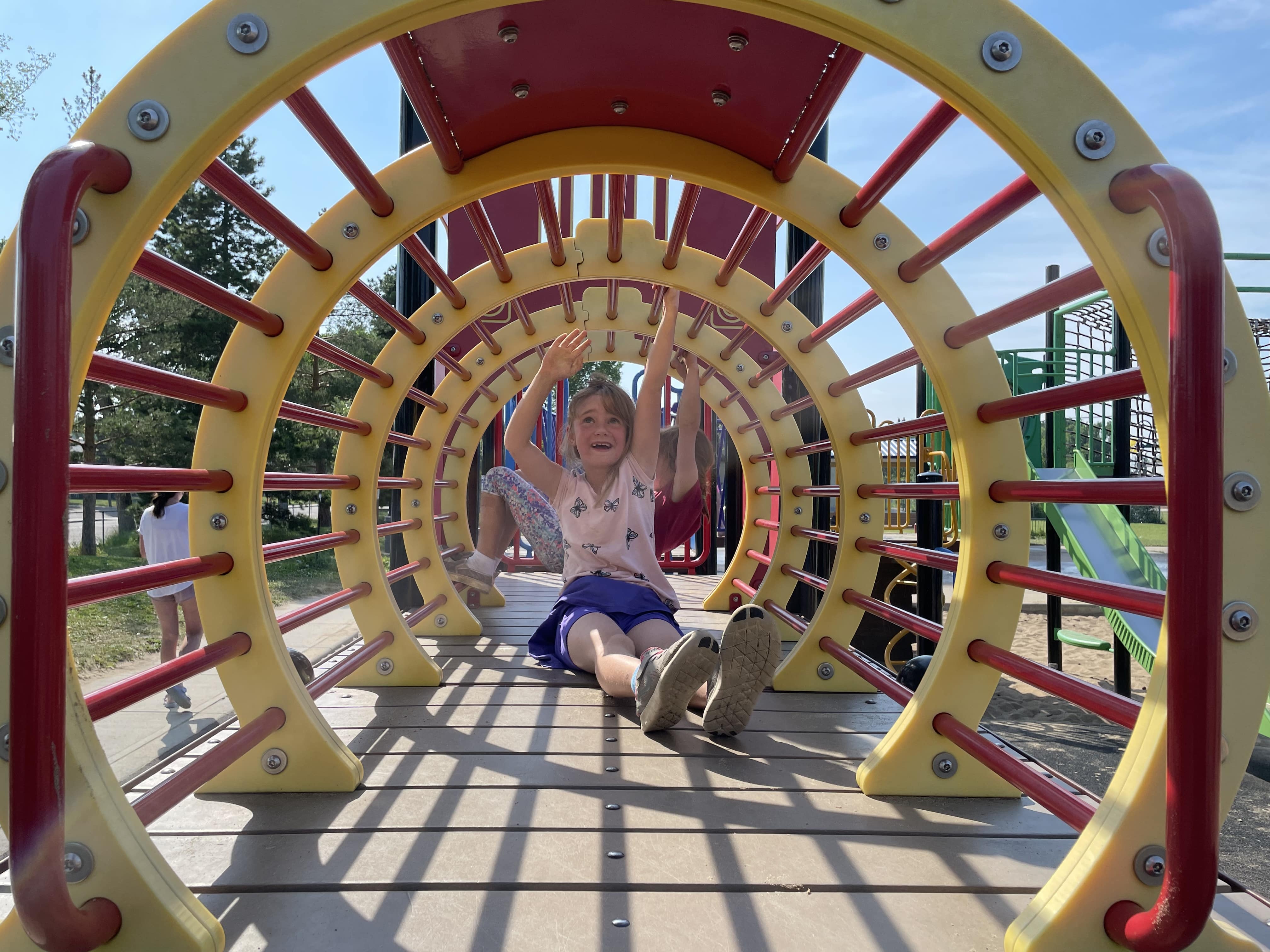 Hazeldean Park playground equipment in Edmonton, AB showing tall rope merry-go-round