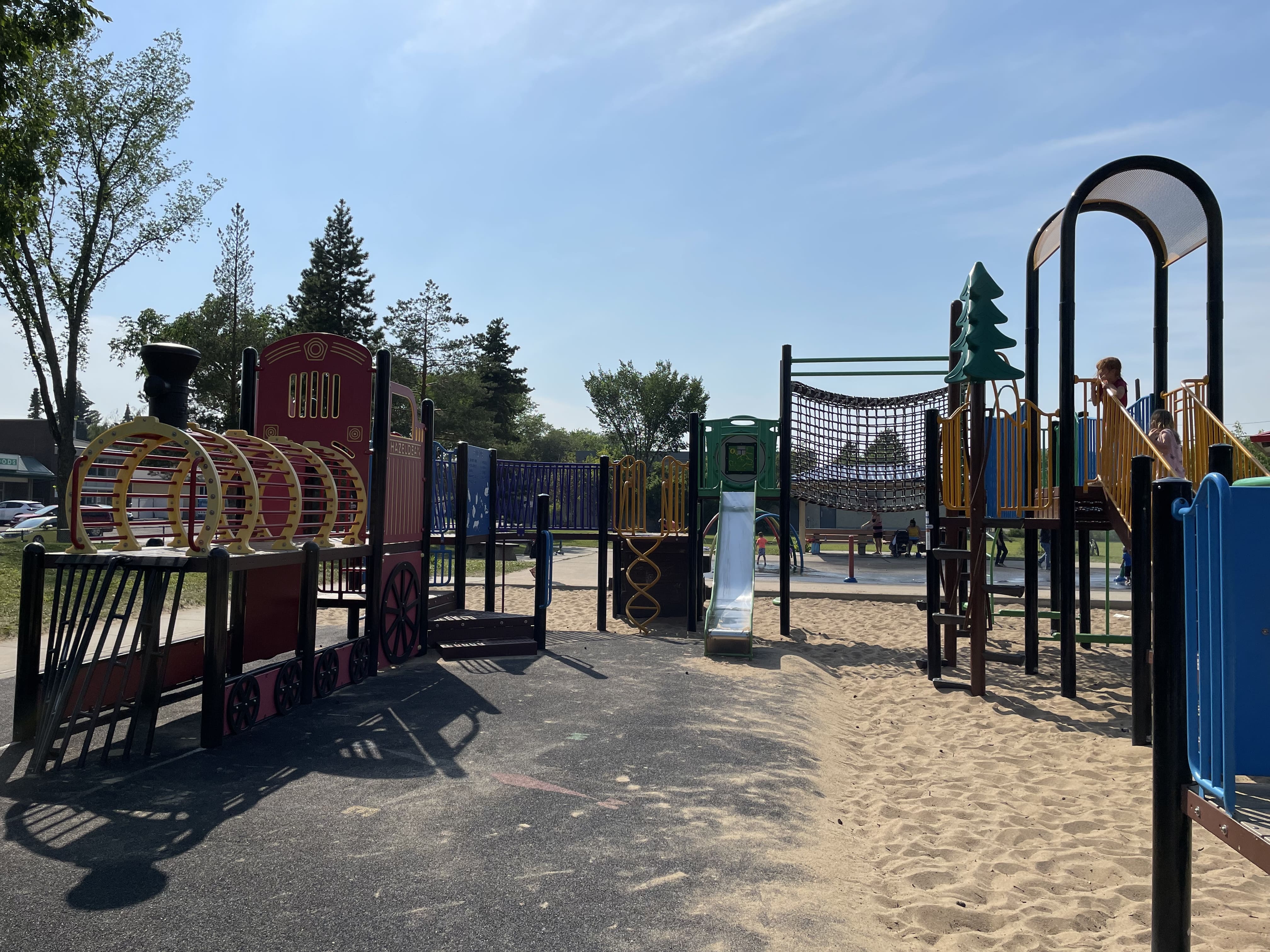 Hazeldean Park playground equipment in Edmonton, AB with umbrella spinner rainbow suncatcher