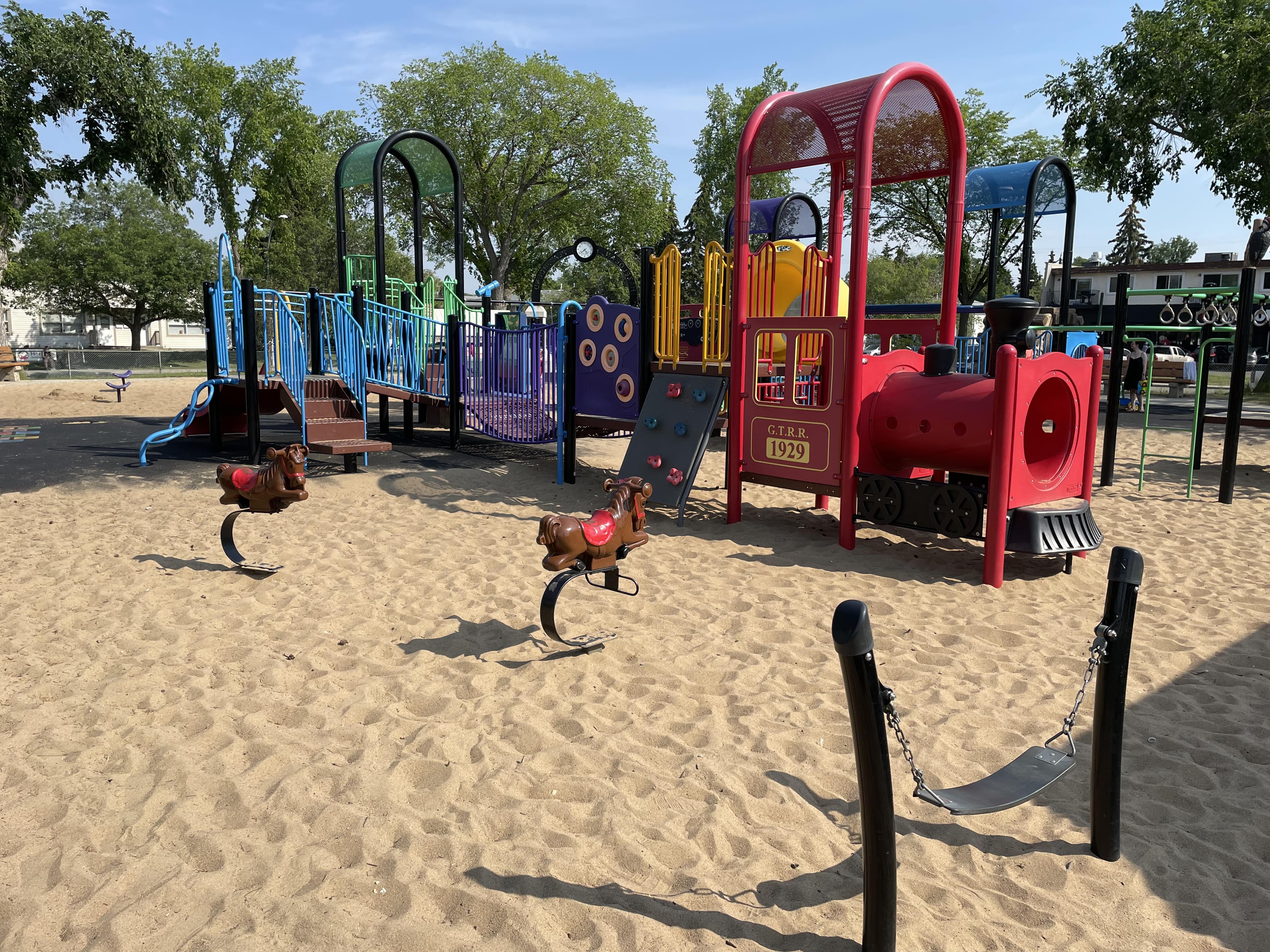 Hazeldean Park playground equipment in Edmonton, AB showing woodchips safety surface