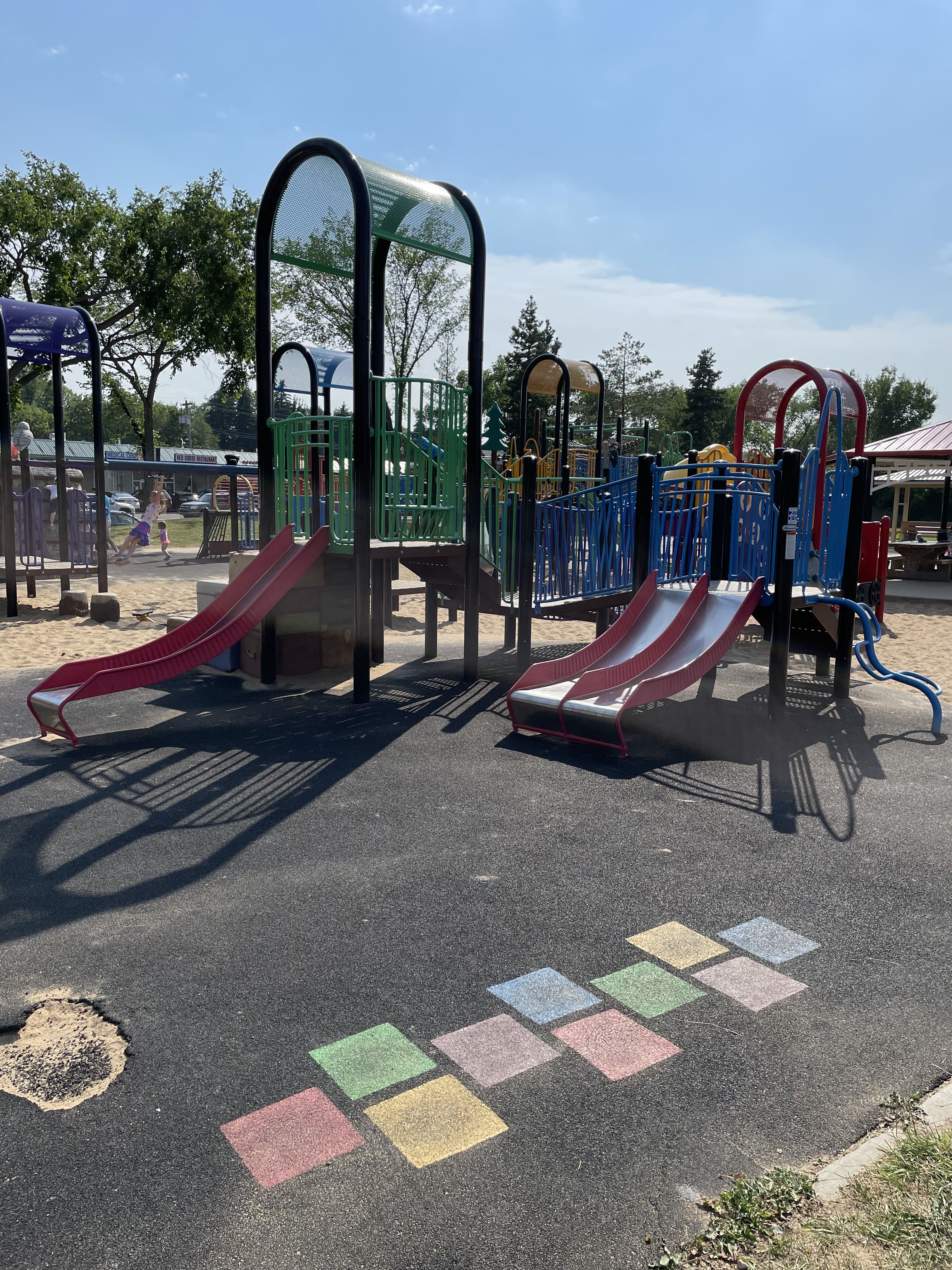 Hazeldean Park playground equipment in Edmonton, AB with two great train structures