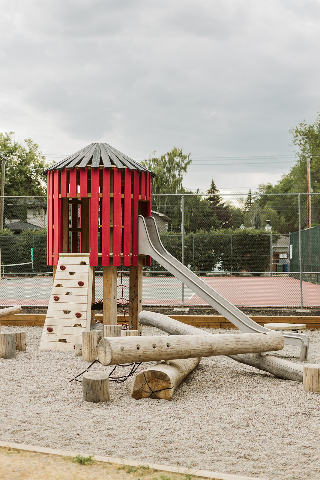 Rideau Roxboro Natural Community Playground playground equipment in Calgary, AB featuring climbing and sliding features