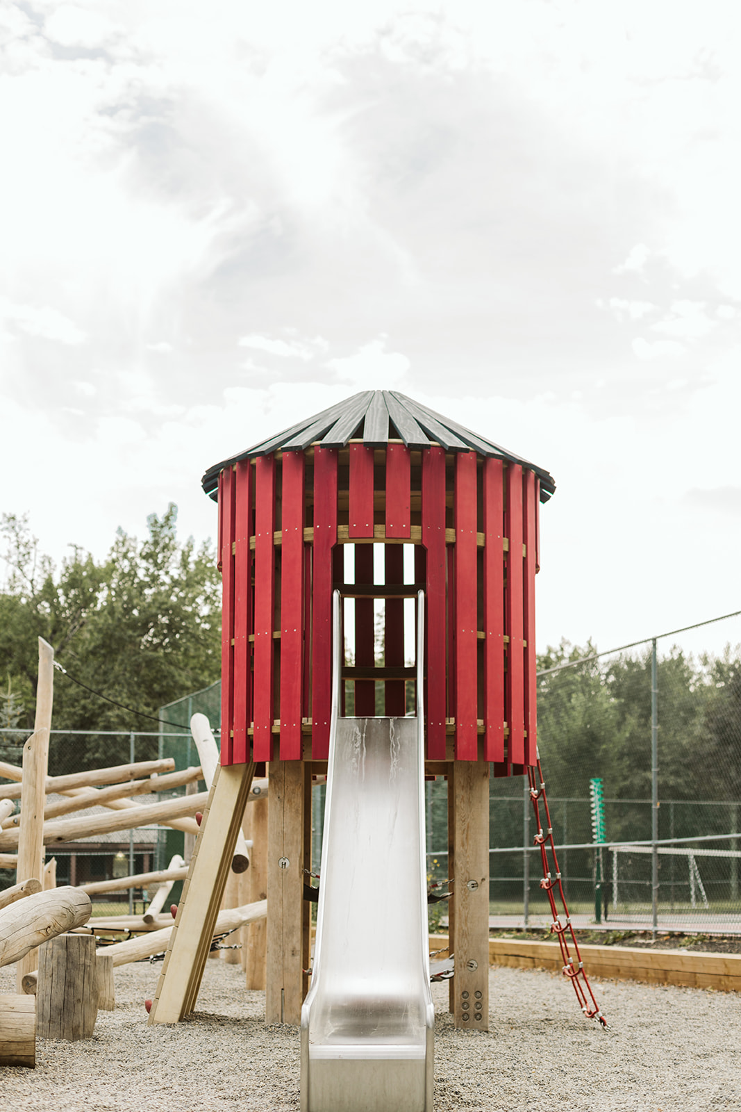 Rideau Roxboro Natural Community Playground playground equipment in Calgary, AB showing school playground safety features