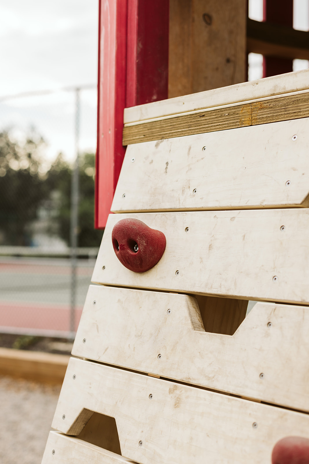 Rideau Roxboro Natural Community Playground playground equipment in Calgary, AB with pea gravel safety surfacing