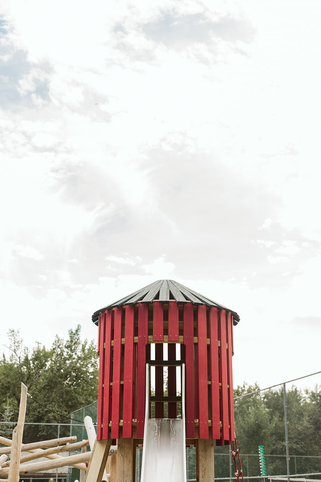 Rideau Roxboro Natural Community Playground playground equipment in Calgary, AB featuring rubber safety surfacing