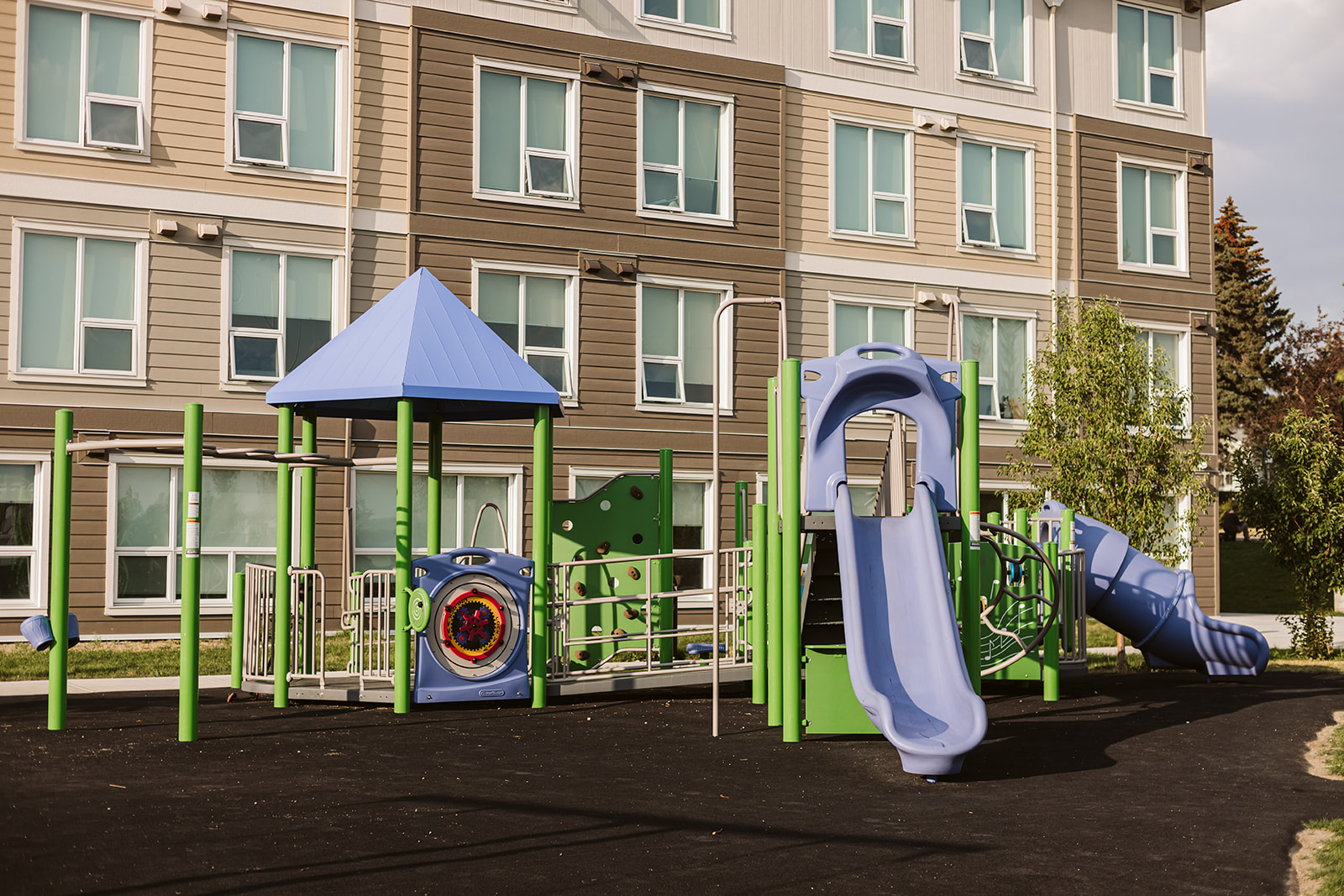 Horizon Housing in Calgary, AB featuring playground equipment with accessible housing playground, residential community
