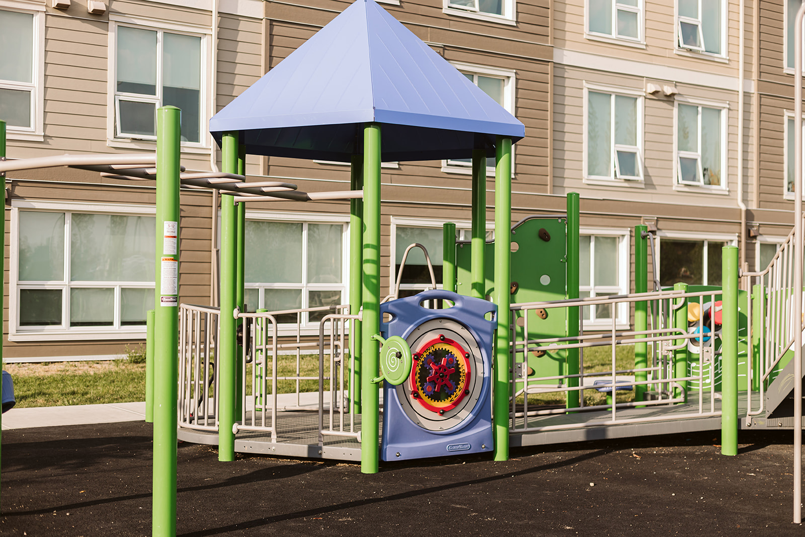 Horizon Housing playground equipment in Calgary, AB featuring climbing and sliding features