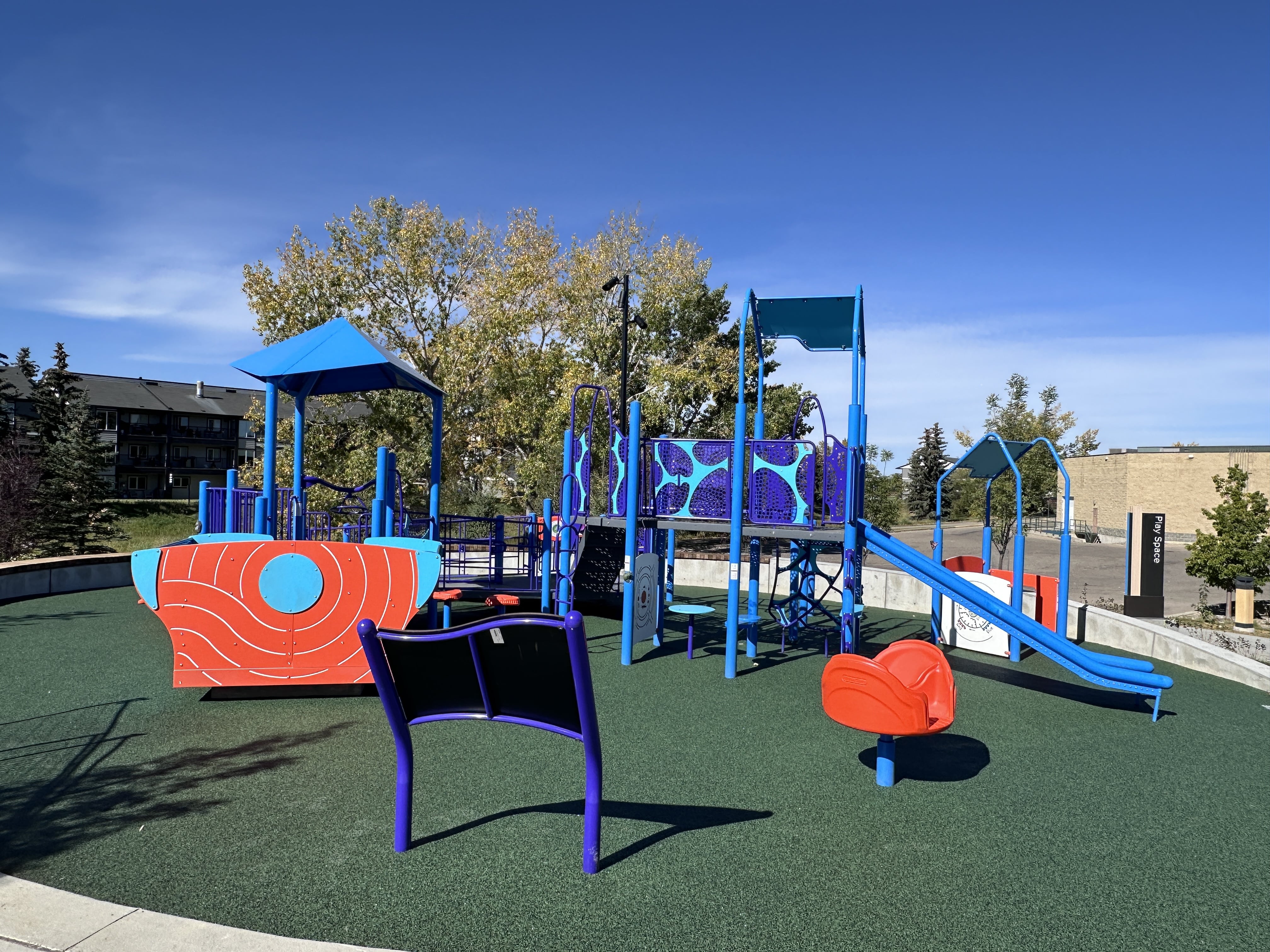 Inspire Playground playground in Airdrie, AB - children playing on equipment