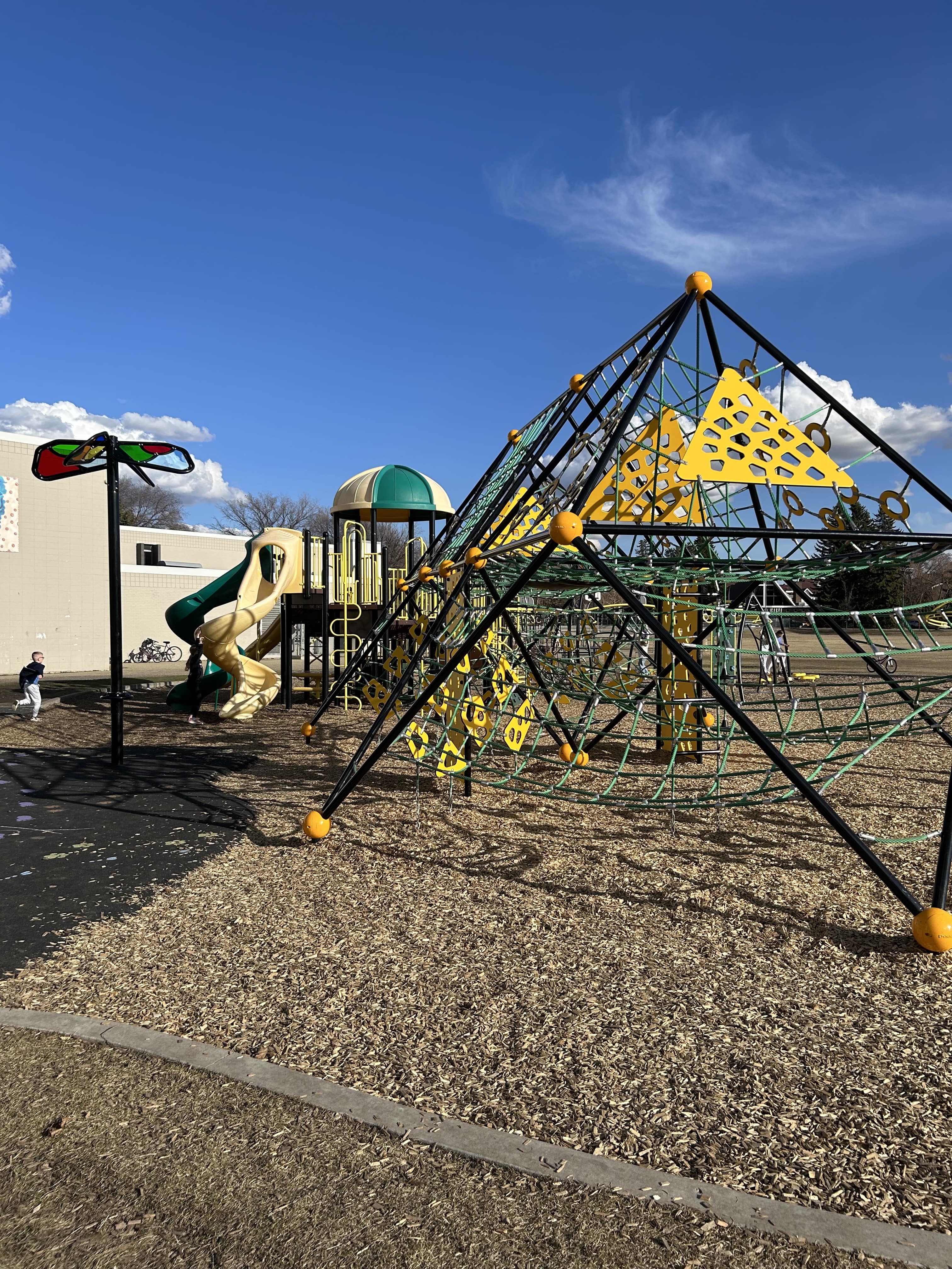 Hardisty School (Edmonton, AB) playground in Edmonton, AB - children playing on equipment