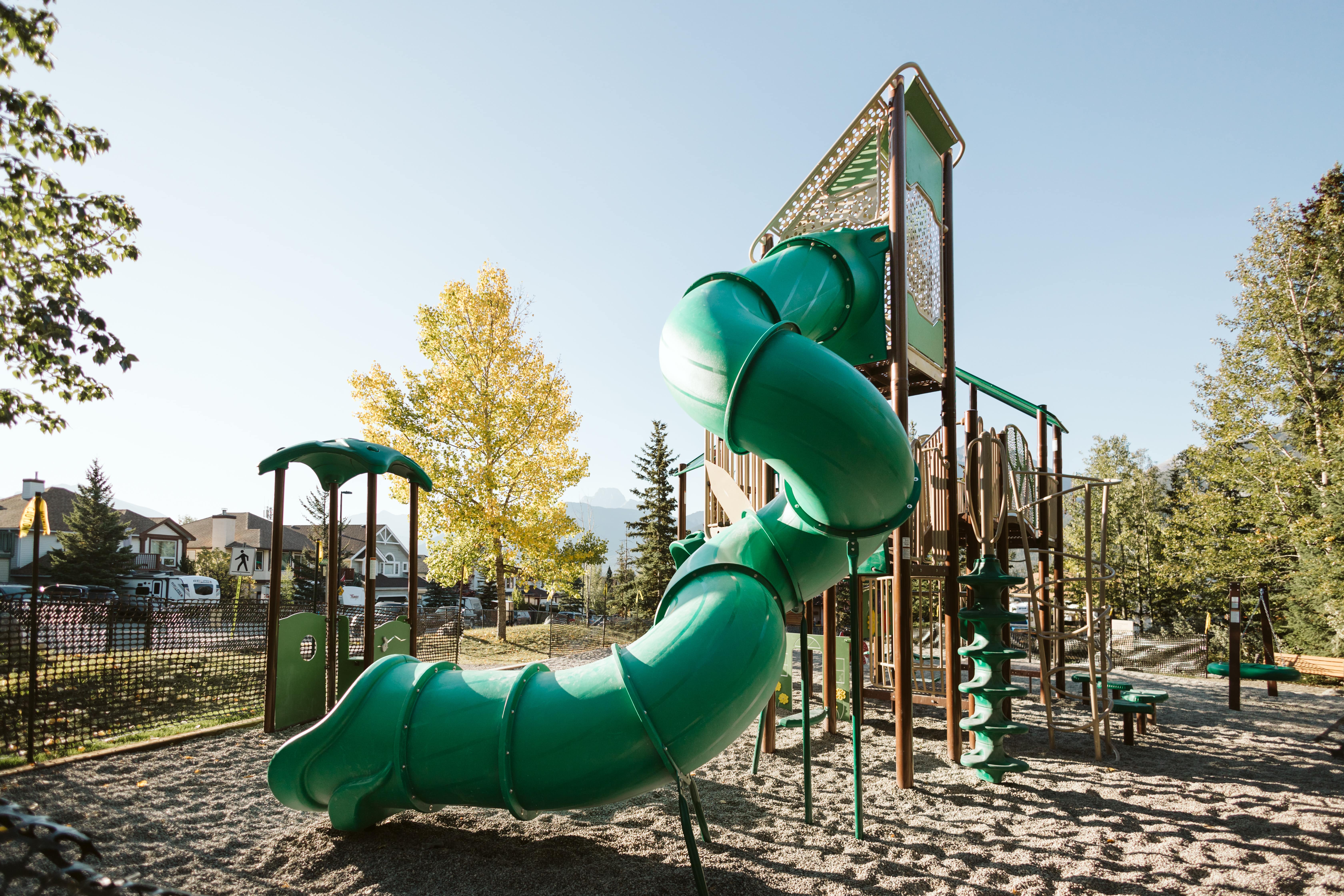 Lady MacDonald Park (Canmore, AB) playground in Canmore, AB - children playing on equipment