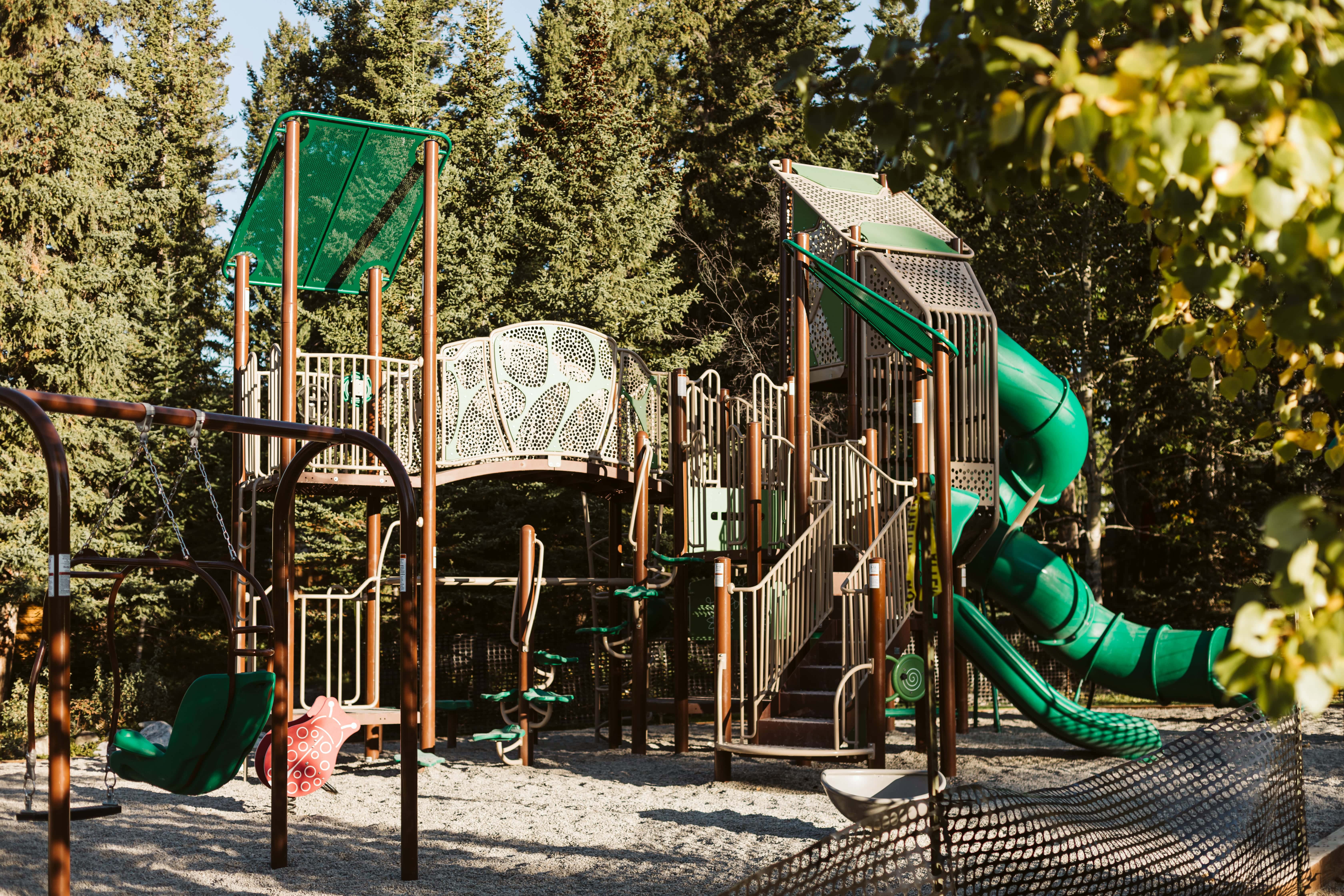 Lady MacDonald Park (Canmore, AB) playground in Canmore, AB - children playing on equipment