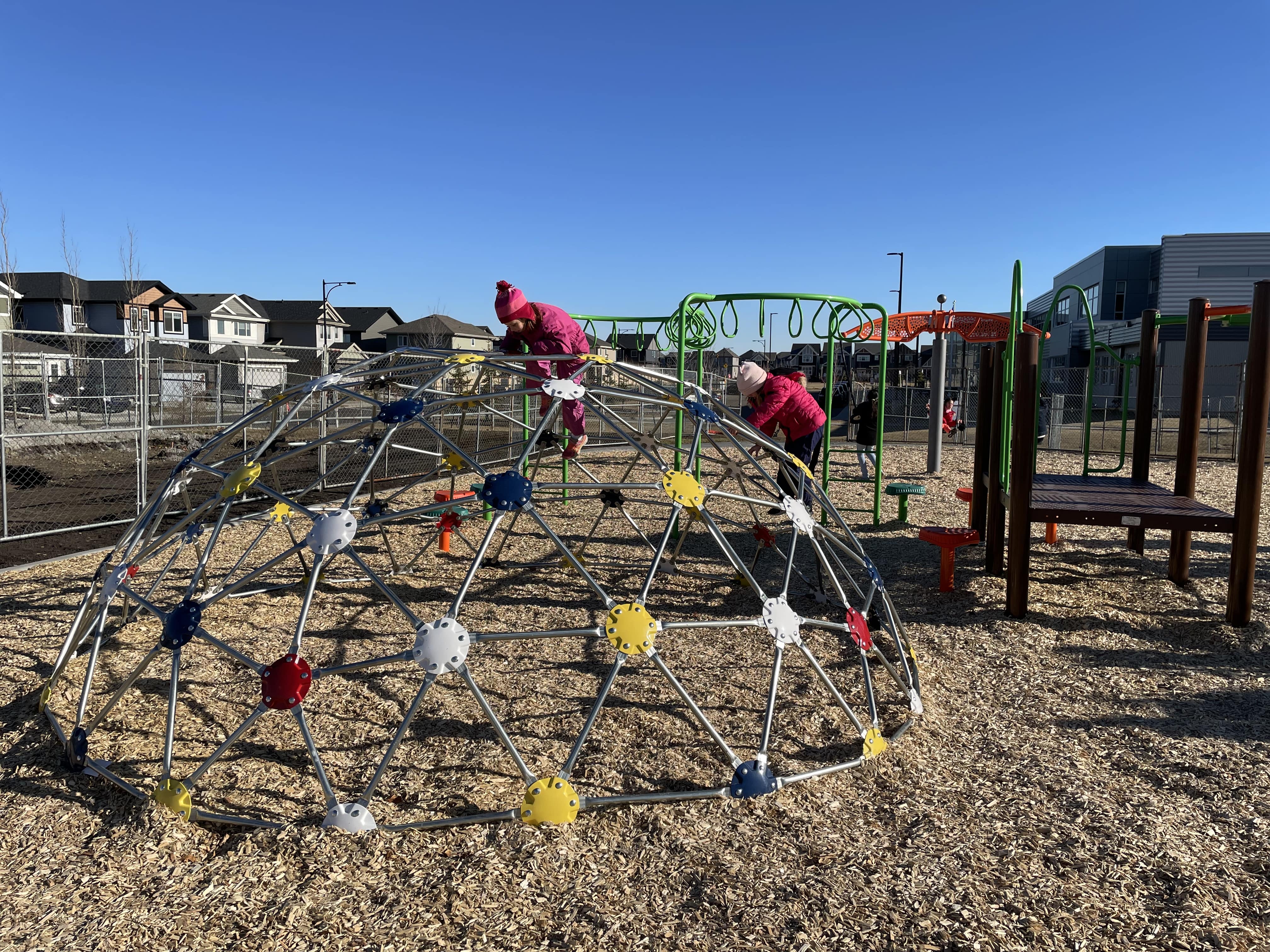 Shauna May Seneca School (Edmonton, AB) playground in Edmonton, AB - children playing on equipment