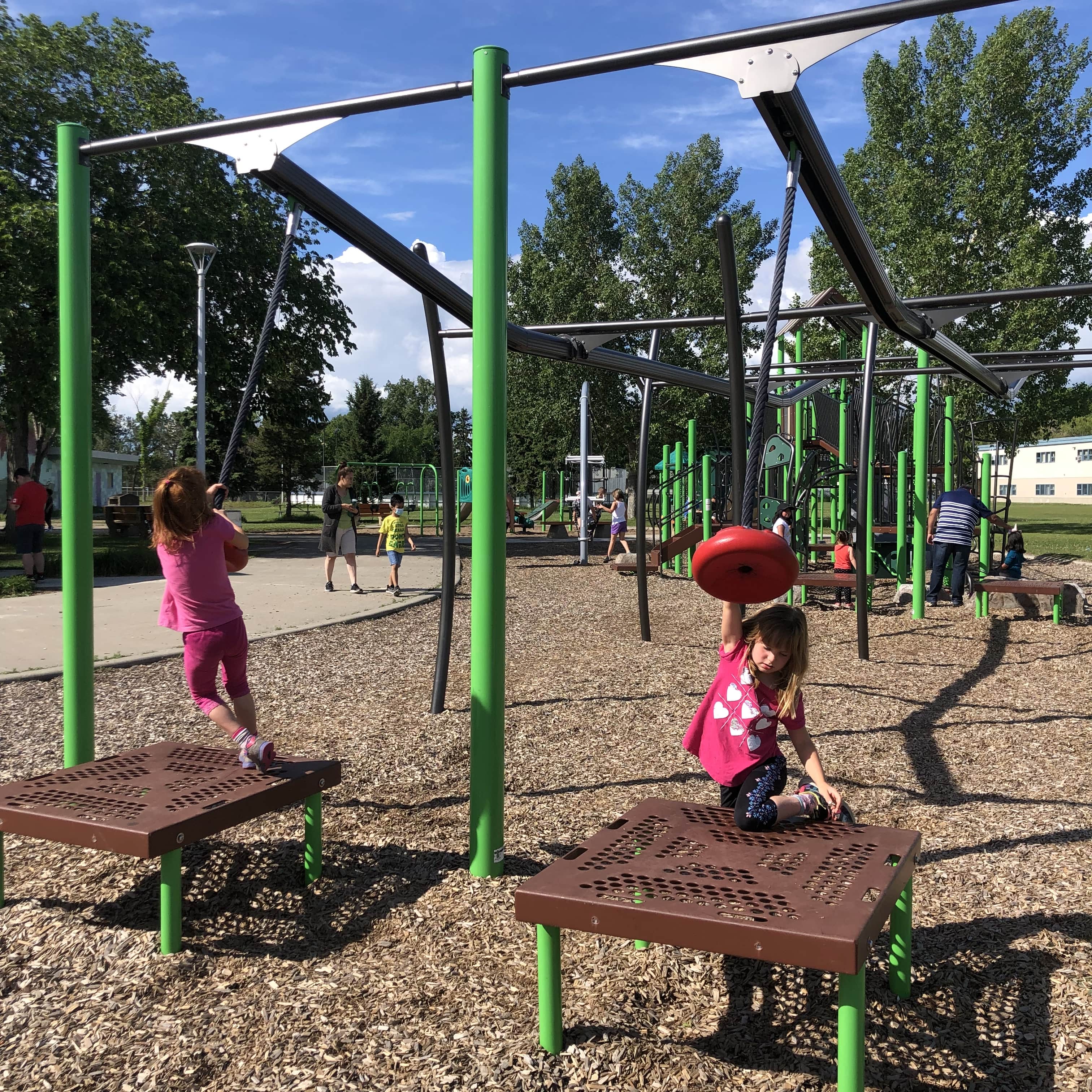 Meadowlark Park (Edmonton, AB) playground in Edmonton, AB - children playing on equipment