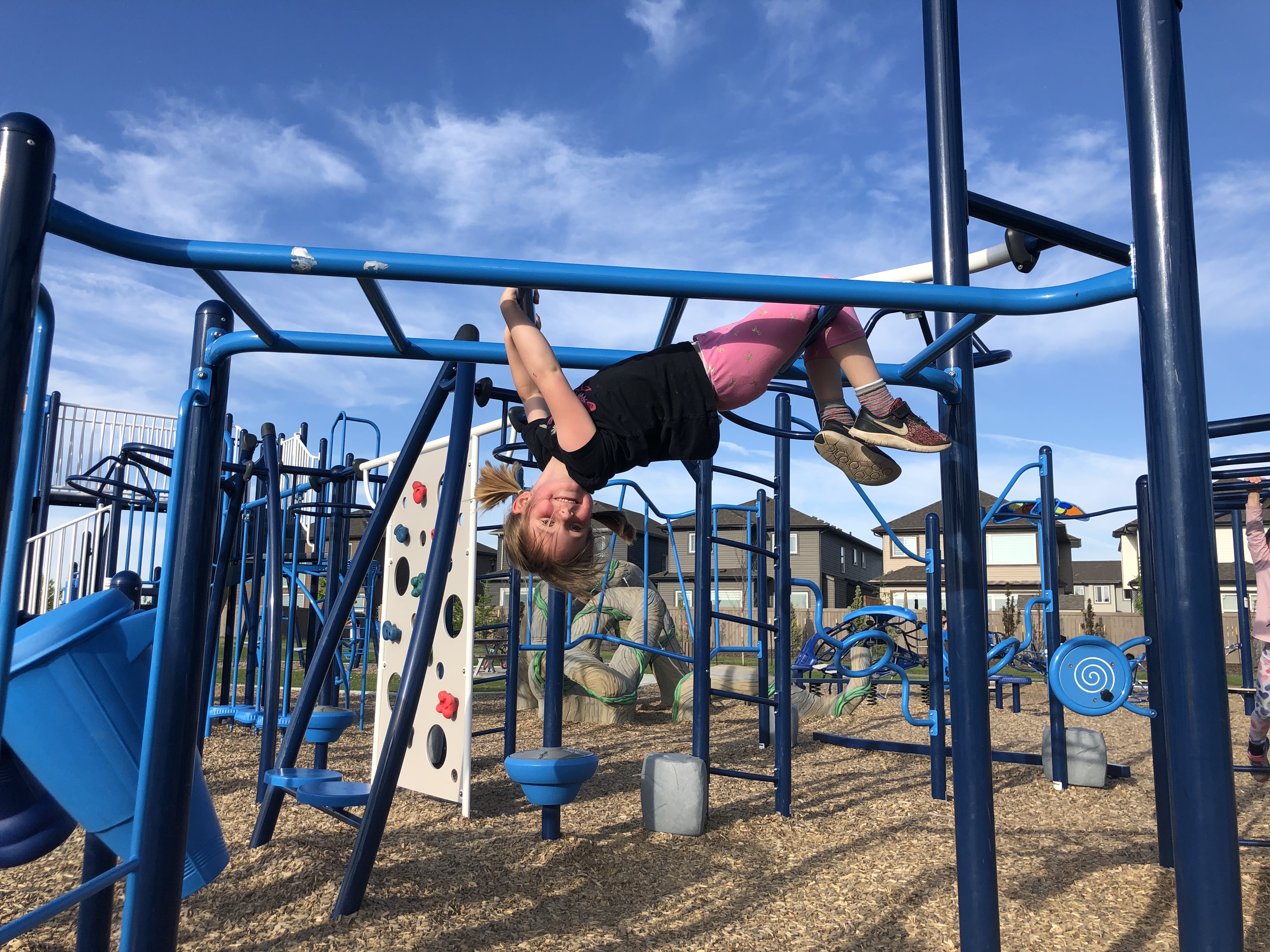 Svend Hanson School (Edmonton, AB) playground in Edmonton, AB - children playing on equipment