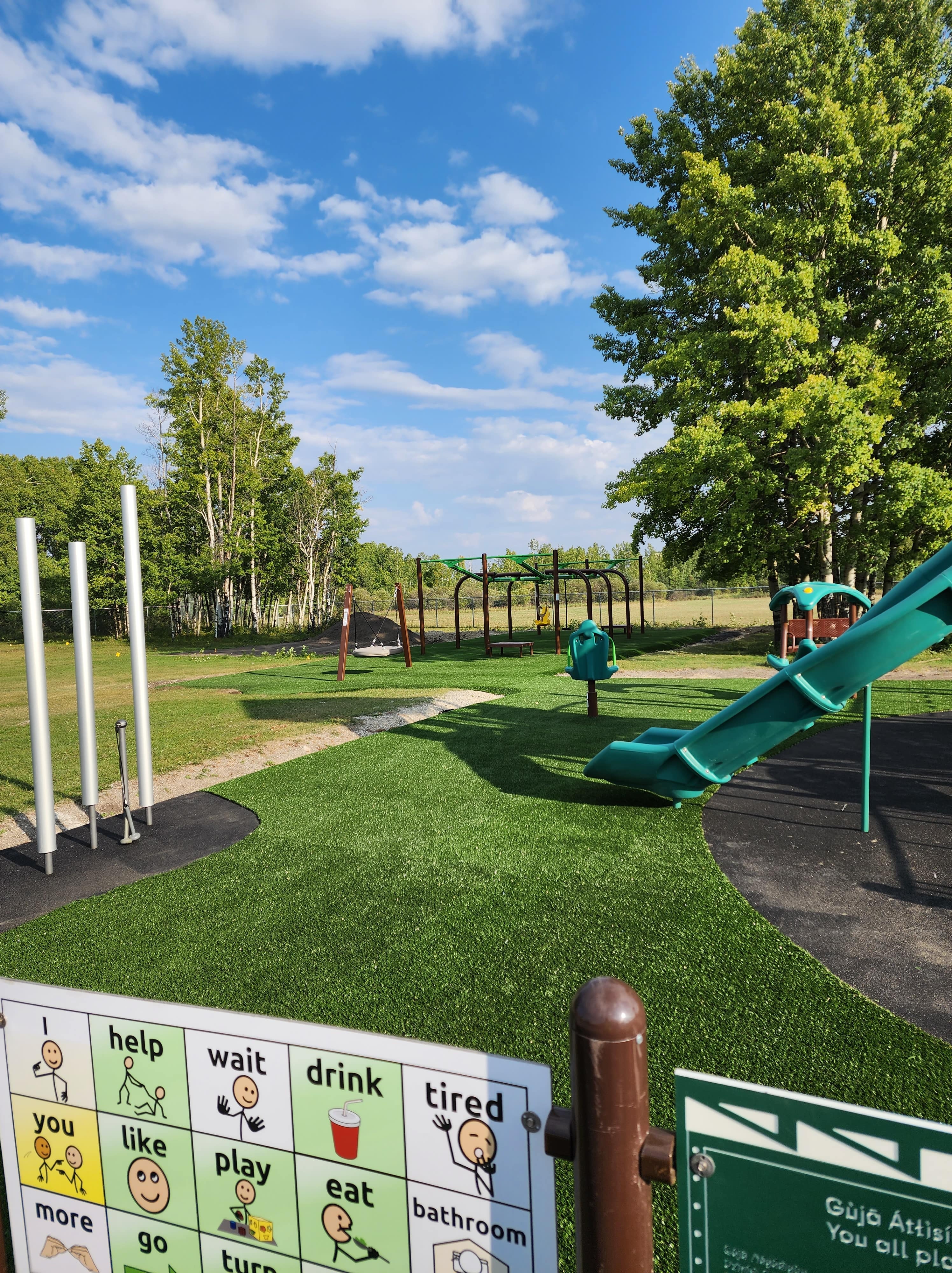 Chiila School (Tsuut-ina Reserve, AB) playground in Tsuut-ina Reserve, AB - playground swings and slides
