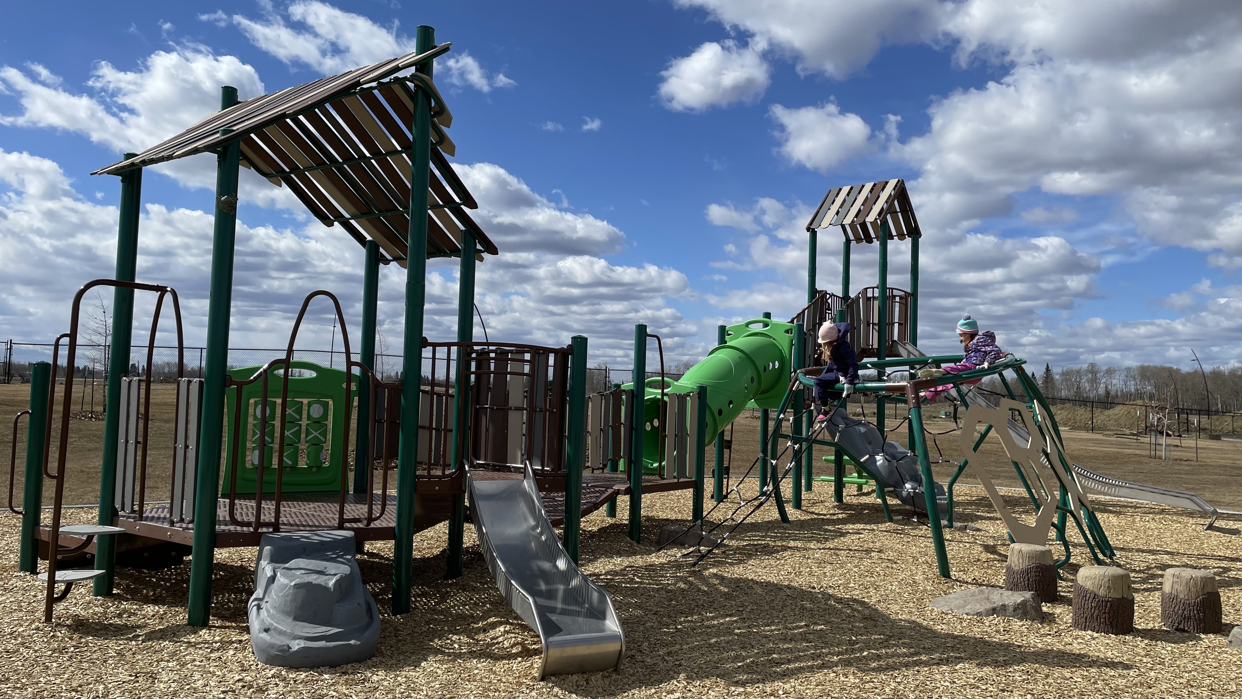 Uplands Playground (Edmonton, AB) playground in Edmonton, AB - children playing on equipment