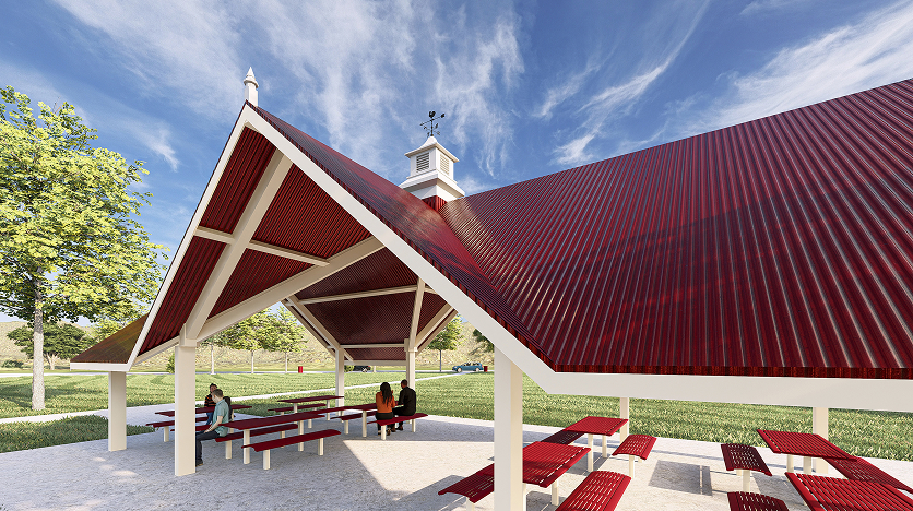 Red-roofed pavilion in a sunny park with trees, housing red picnic tables. Three people sit together, creating a welcoming atmosphere.
