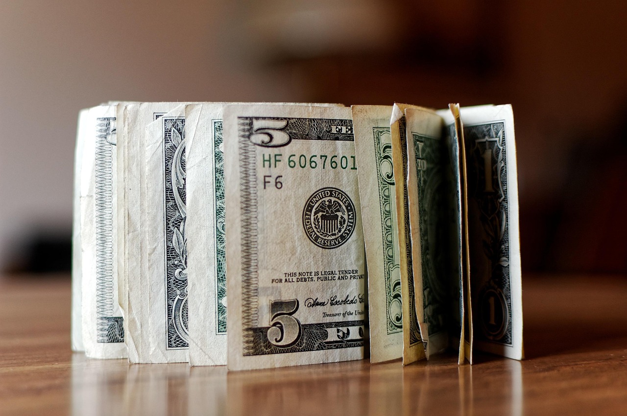 five and one dollar bills on a table