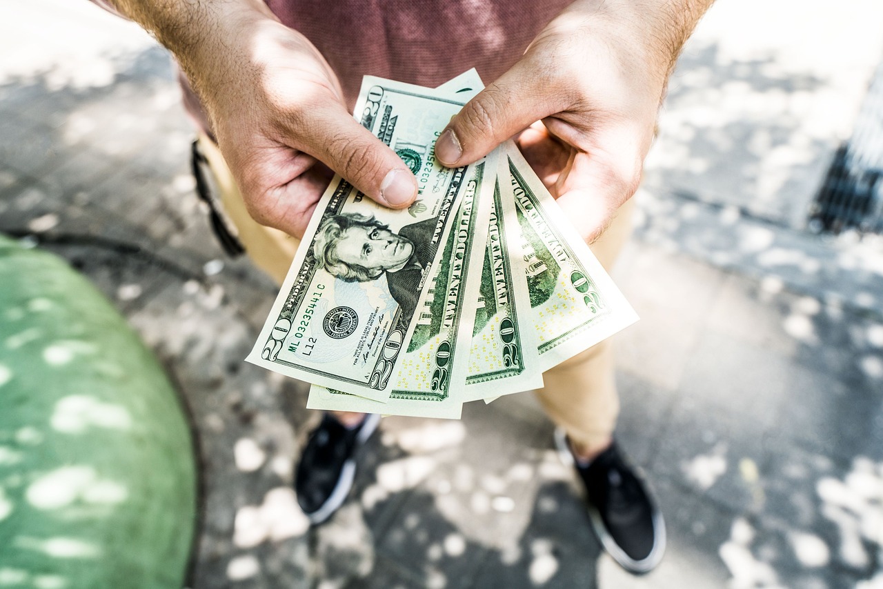hands holding $20 bills