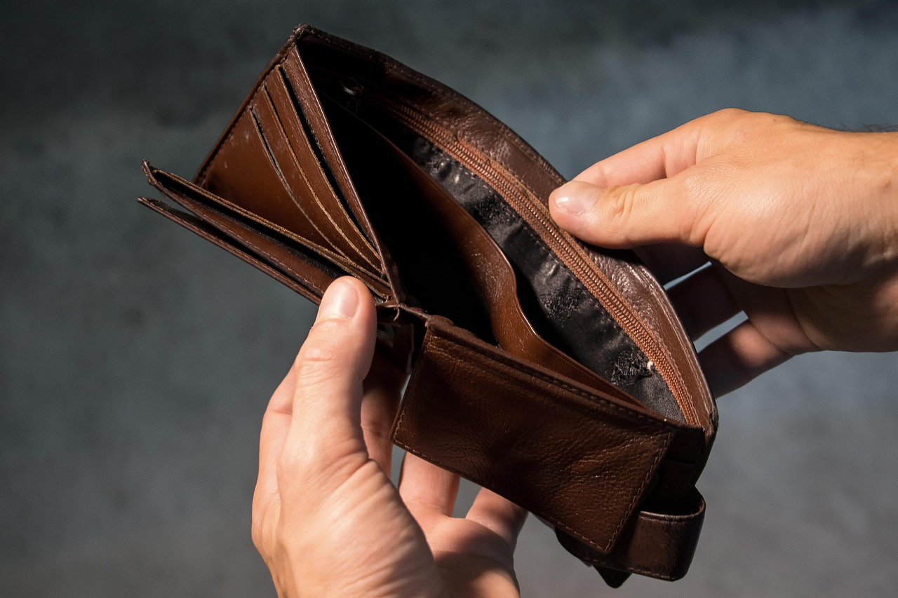 hands holding open an empty leather wallet