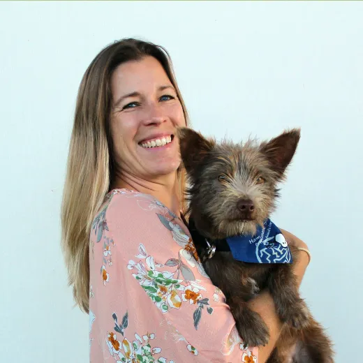 Hawaiian Humane Society CEO holding a dog.