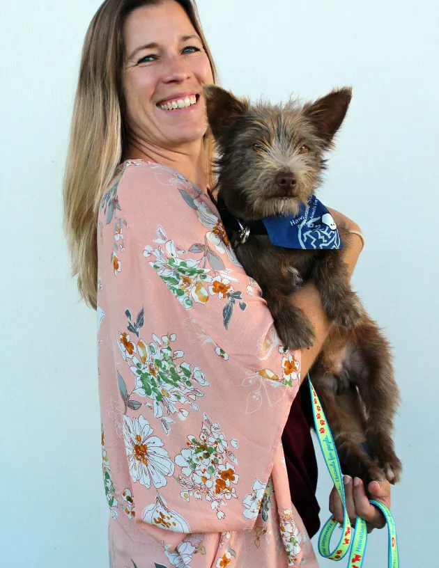 Hawaiian Humane Society CEO holding a dog.