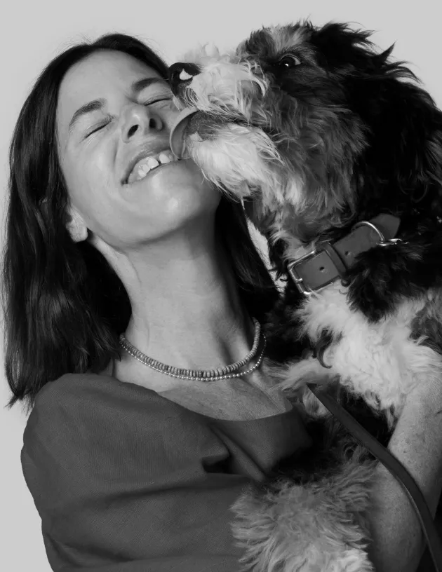 Irene Neuwirth getting kisses from a dog.