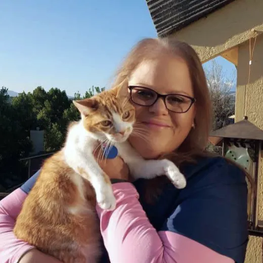 A Fetch employee holding their cat.
