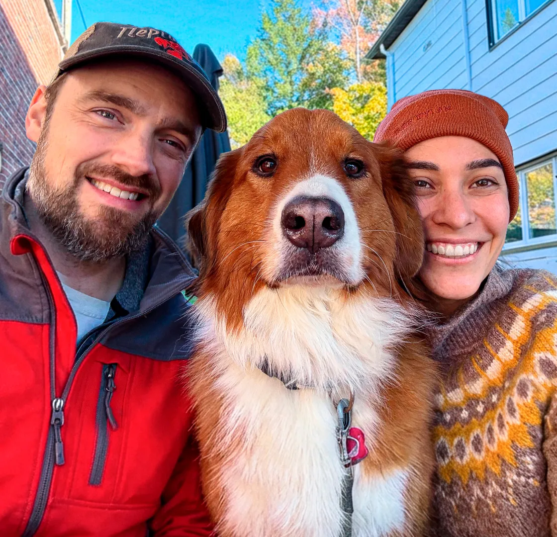 Foxy the dog with their pet parents.