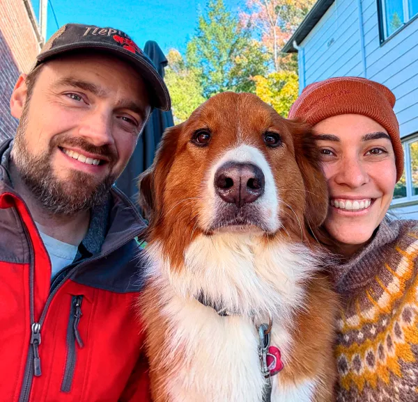 Foxy the dog with their pet parents.