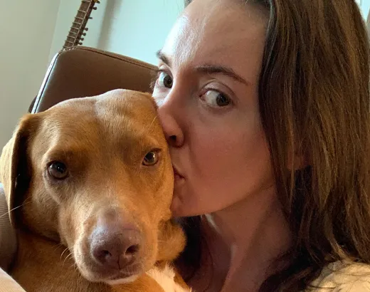 Kali the dog getting a kiss from his mom.