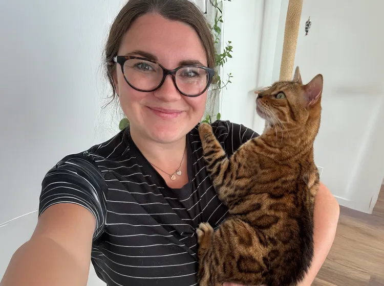 Maple the cat in moms arms.