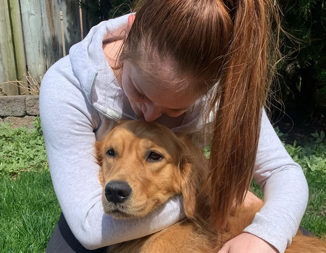 Sage the dog getting kisses from mom.