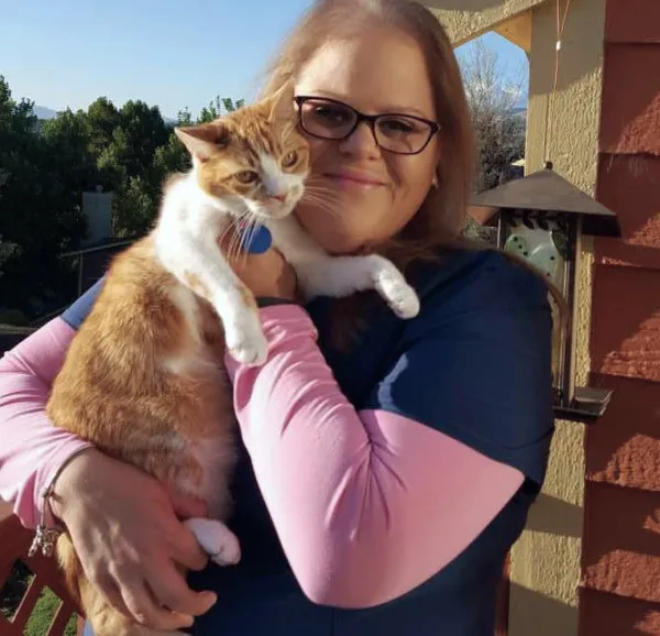 Fetch employee Toni E. holding her cat.