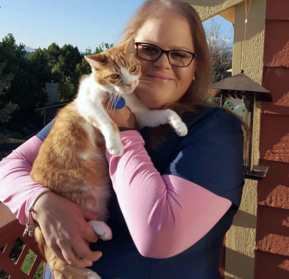 Fetch employee Toni E. holding her cat.