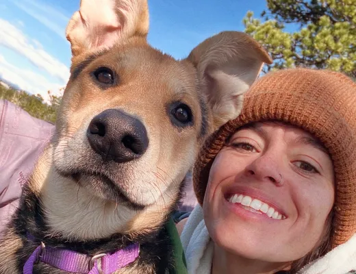A Fetch employee posing with their dog.