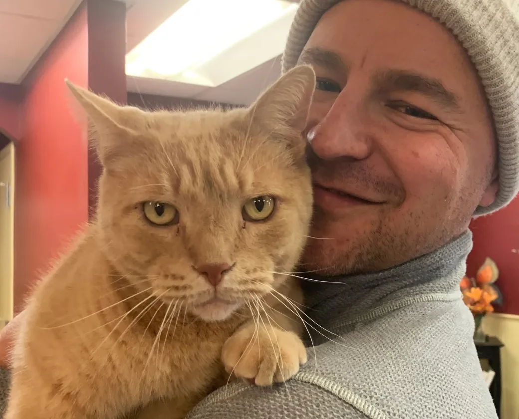Theodore the cat with their owner, Alex.