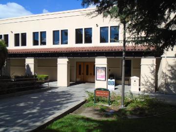 Two-story building with a sign that reads Music and Dance.