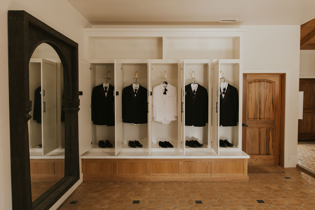 Groomsmen suits hang inside Parlor at Grand Gimeno.