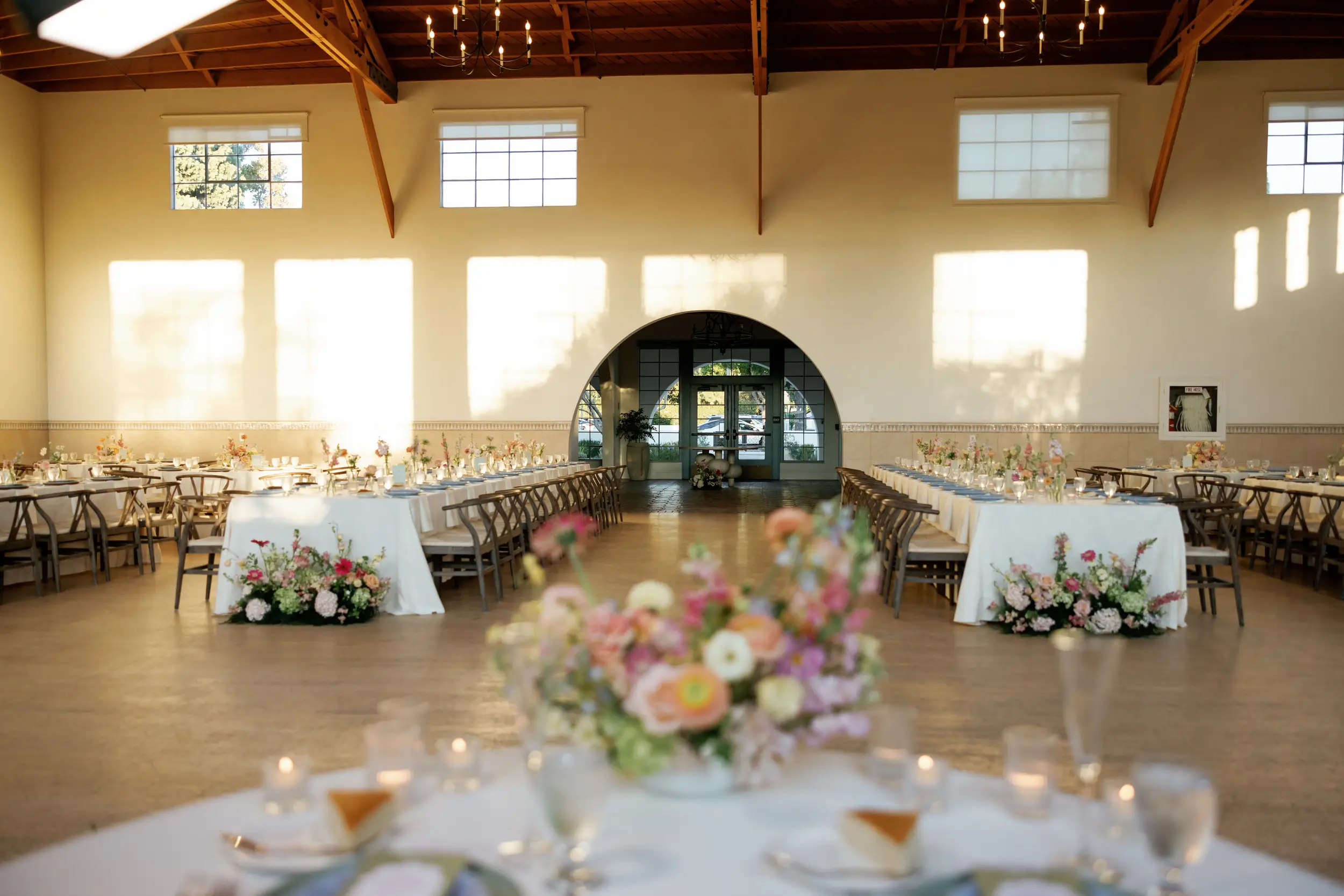 Indoor wedding reception with colorful florals.