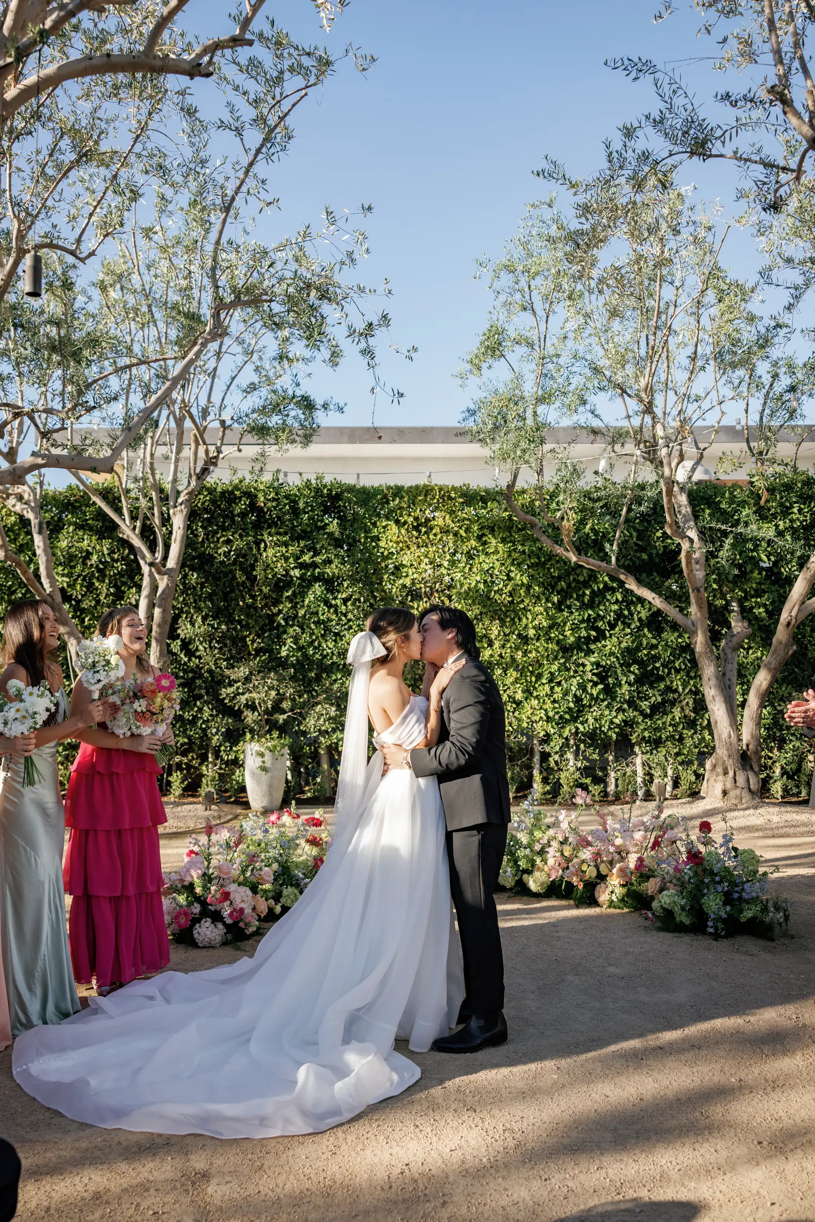 Bride and groom share a ceremony kiss.
