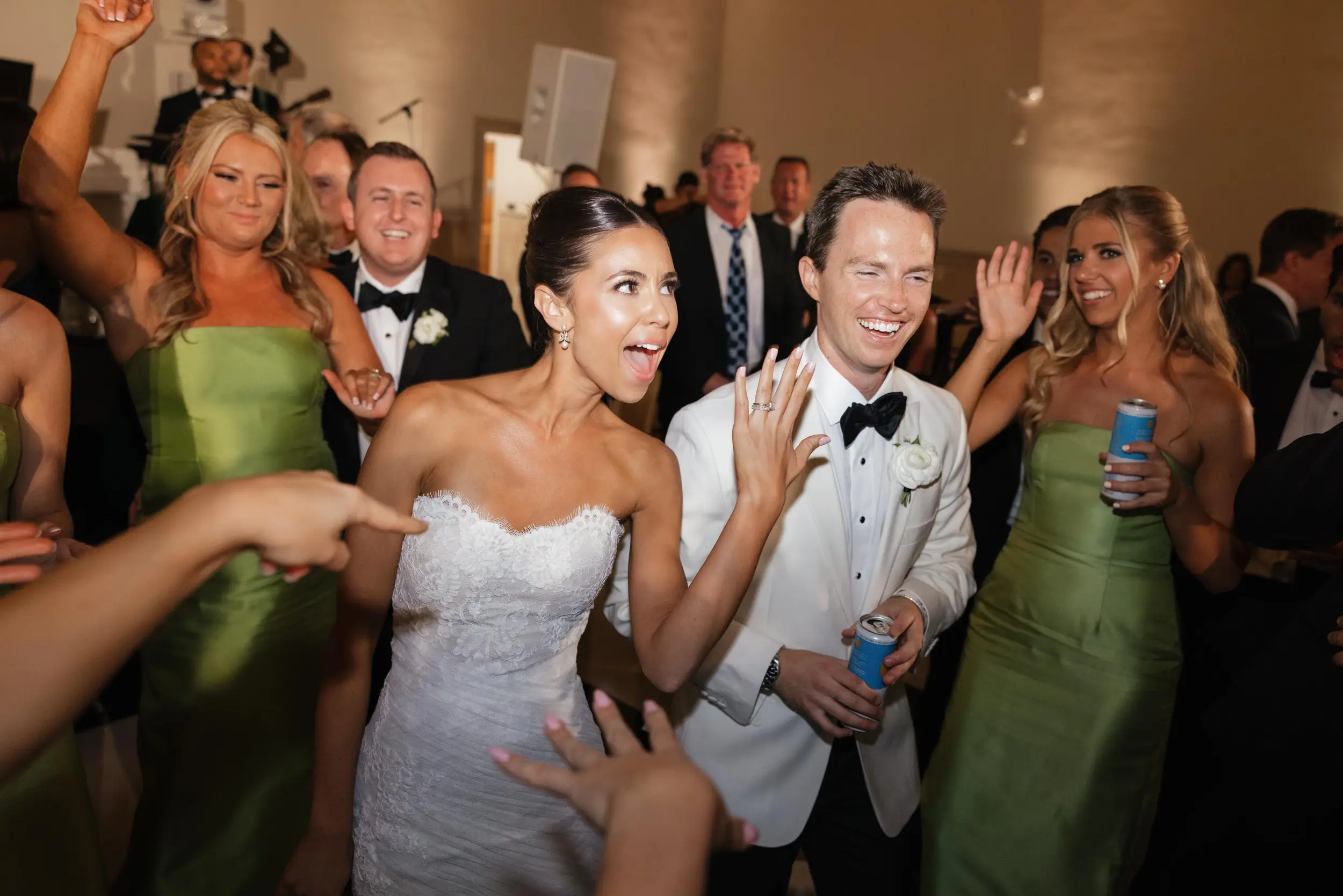 Bride and groom end the night on the dance floor surrounded by friends and family.