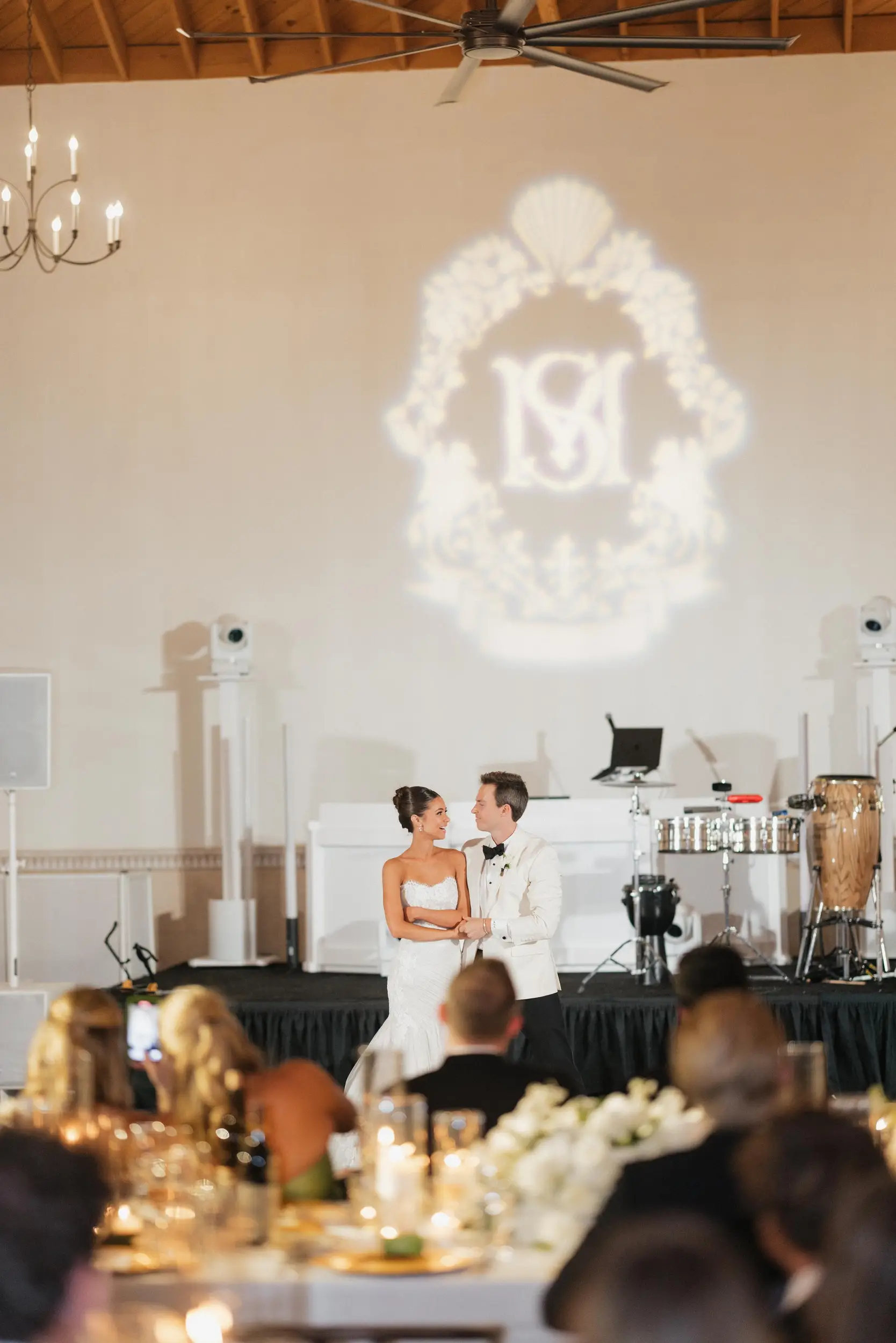 Bride and groom dance on a black and white checkered dance floor for their first dance.