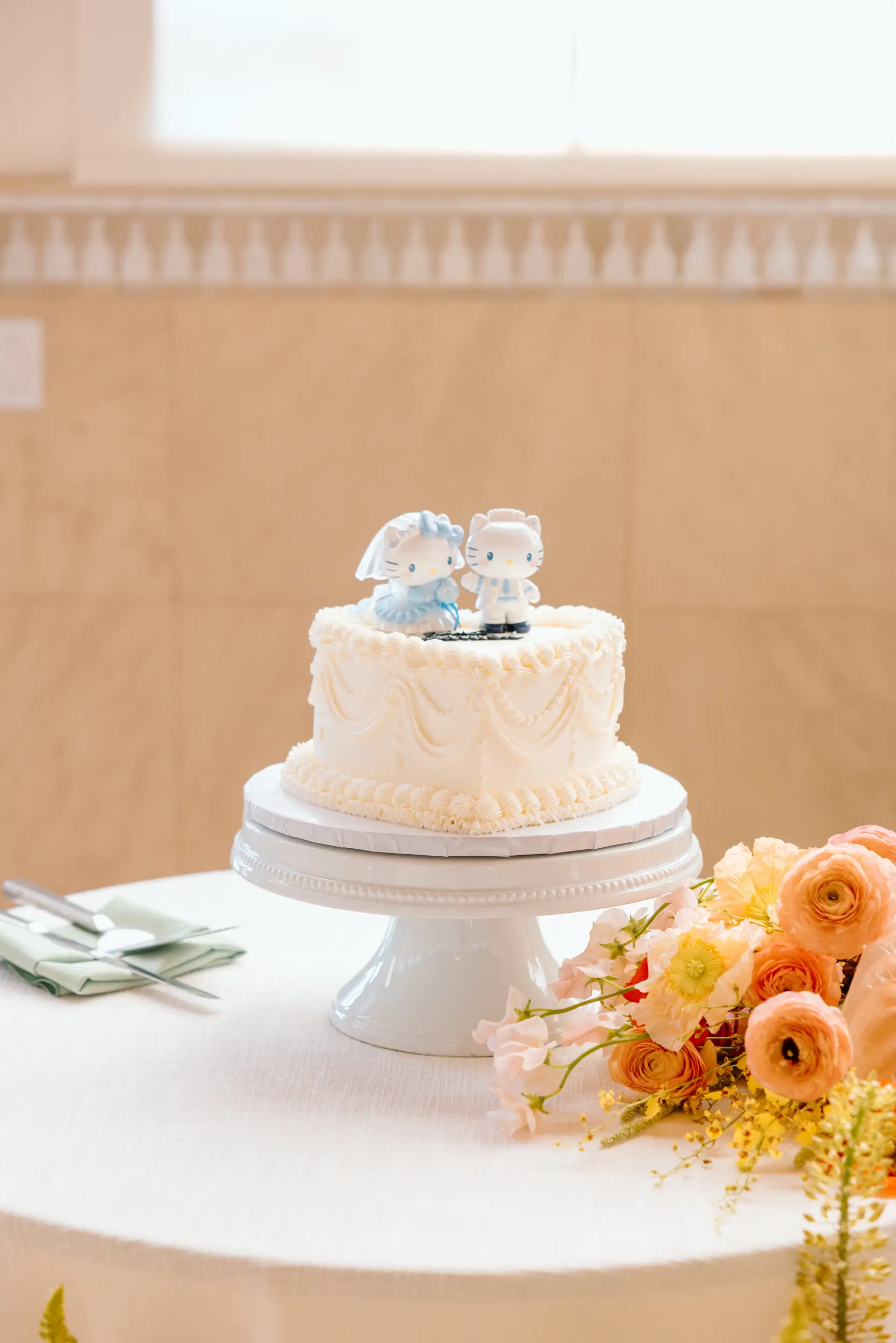 vintage heart wedding cake with Hello Kitty toppers.