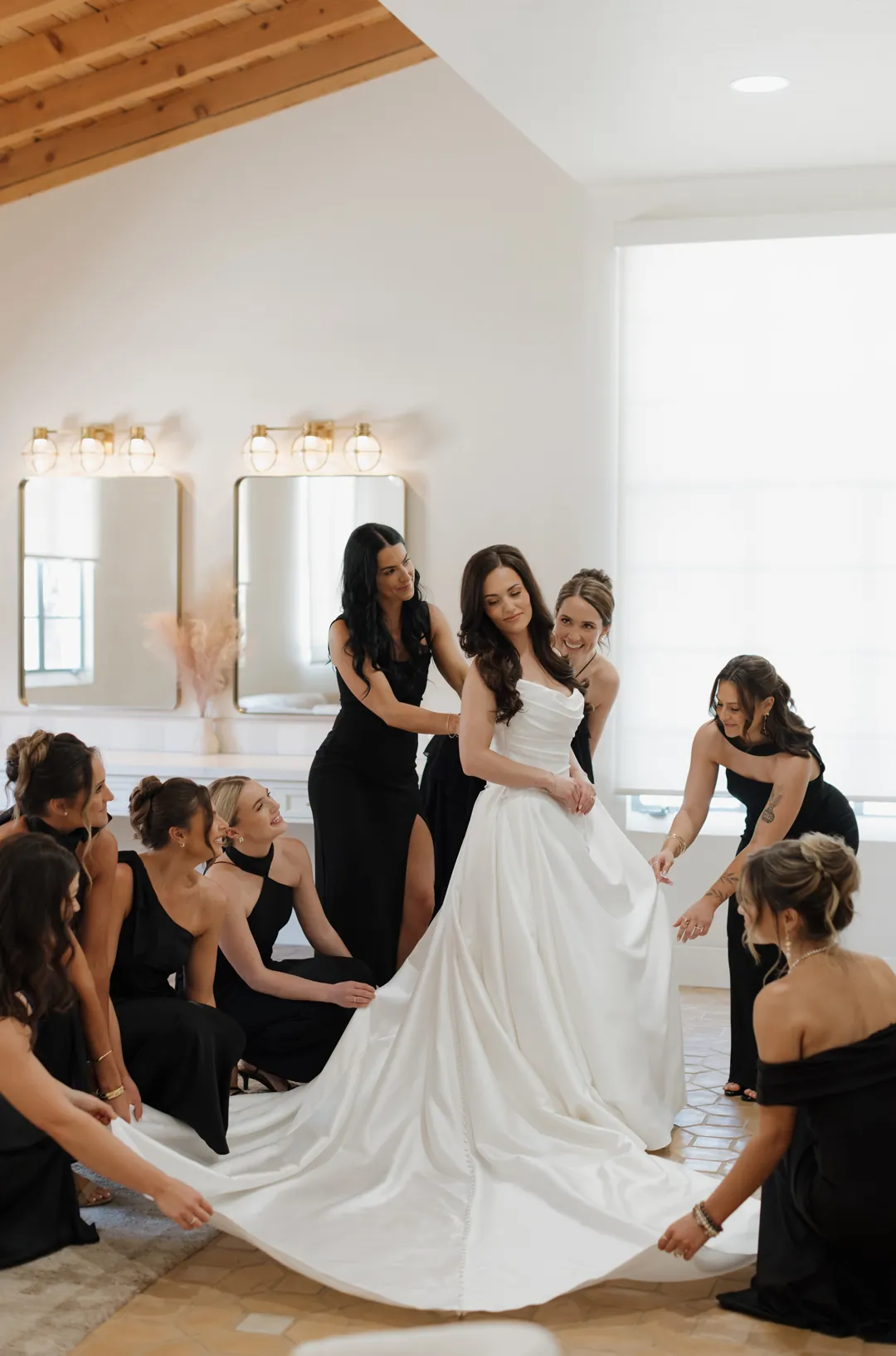Bride getting ready with bridesmaids inside the Spanish Revival Bridal Suite at Grand Gimeno.